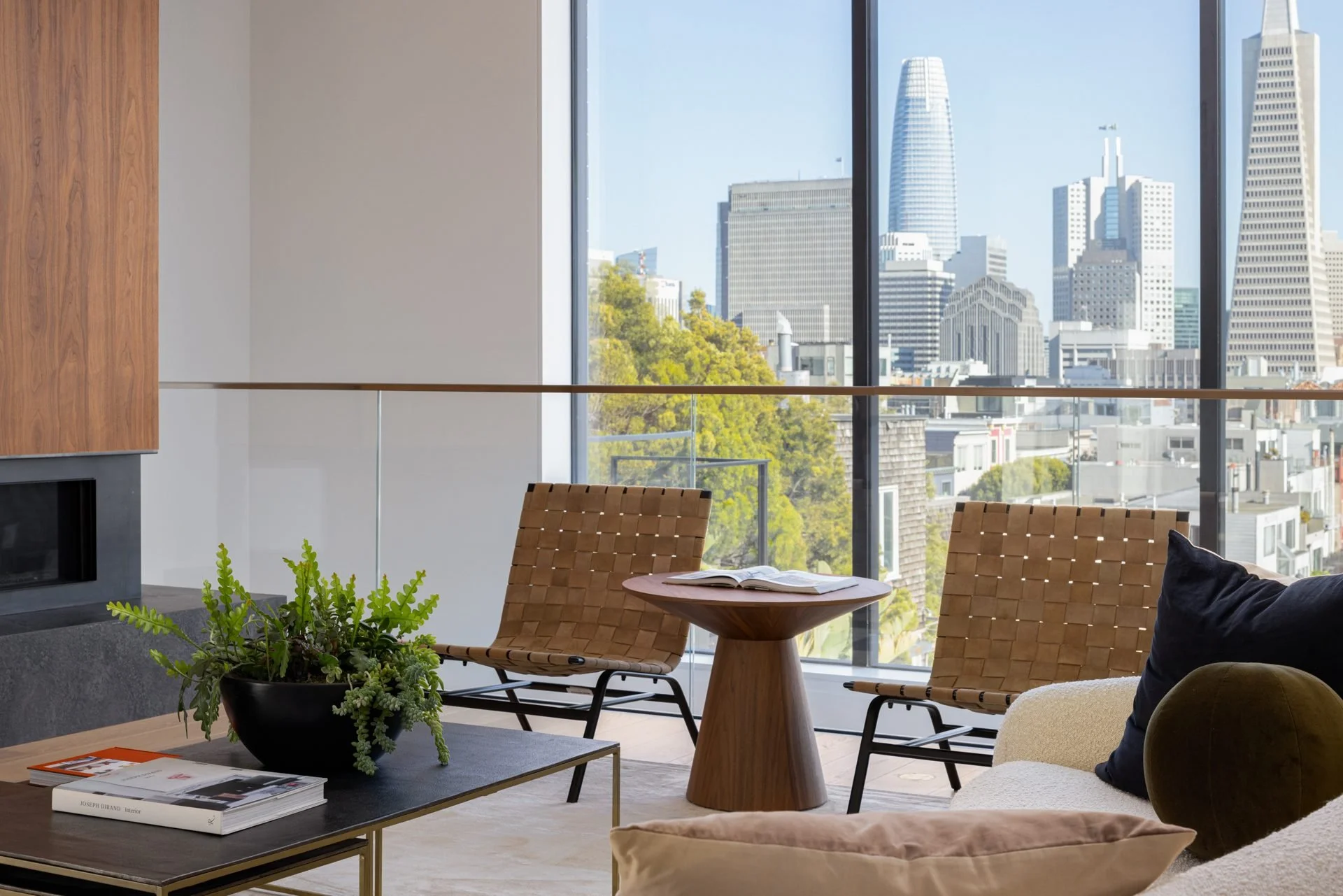 Sitting area with leather chairs beside floor-to-ceiling windows onto Salesforce Tower, 119 Telegraph, San Francisco