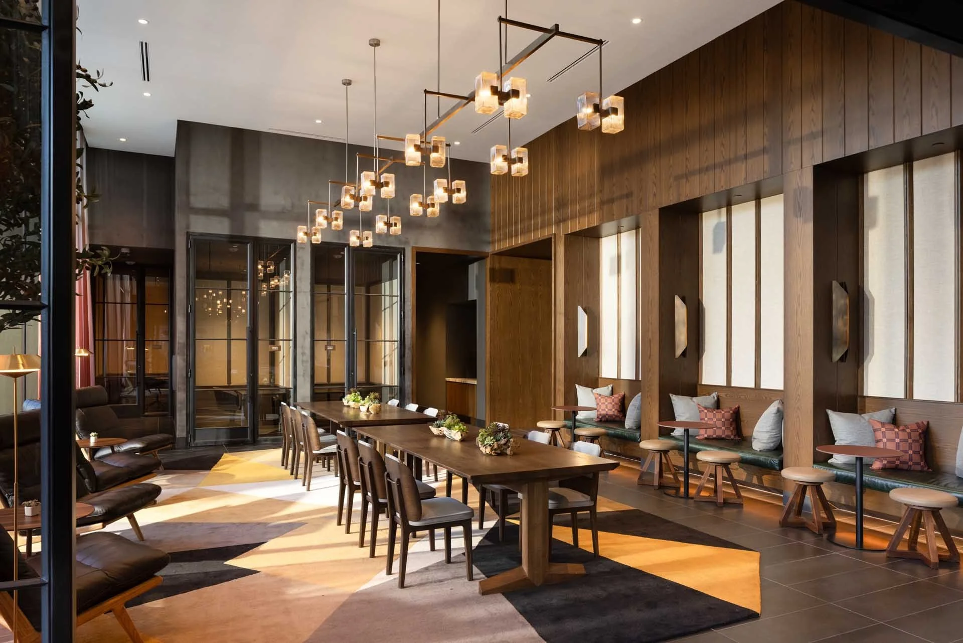 Twenty-Two Lounge with a long communal dining table, pendant lights and banquette seating, The Clara, Santa Clara