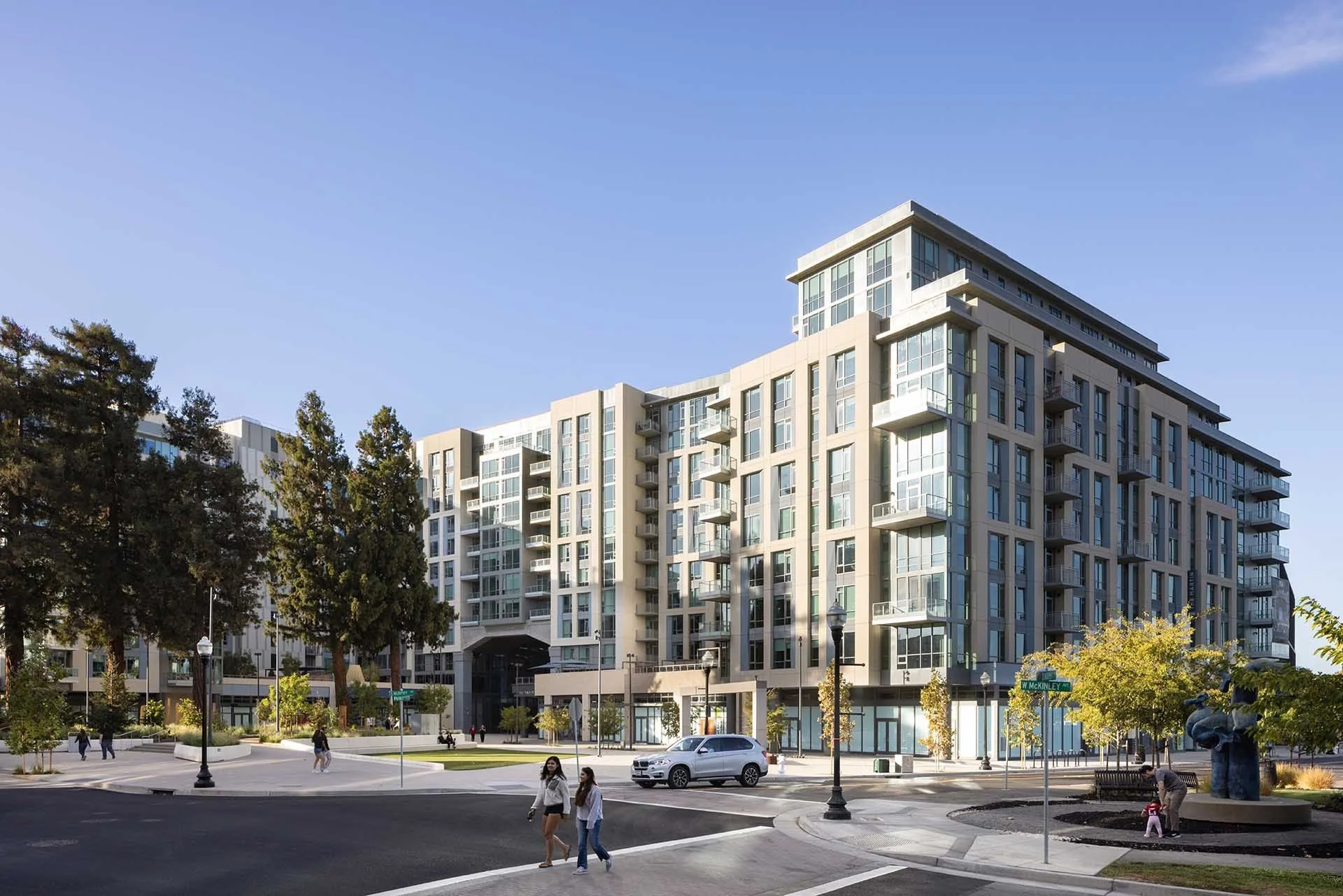 Street view of The Martin mixed-use buildings at CityLine with trees and a crosswalk, Sunnyvale