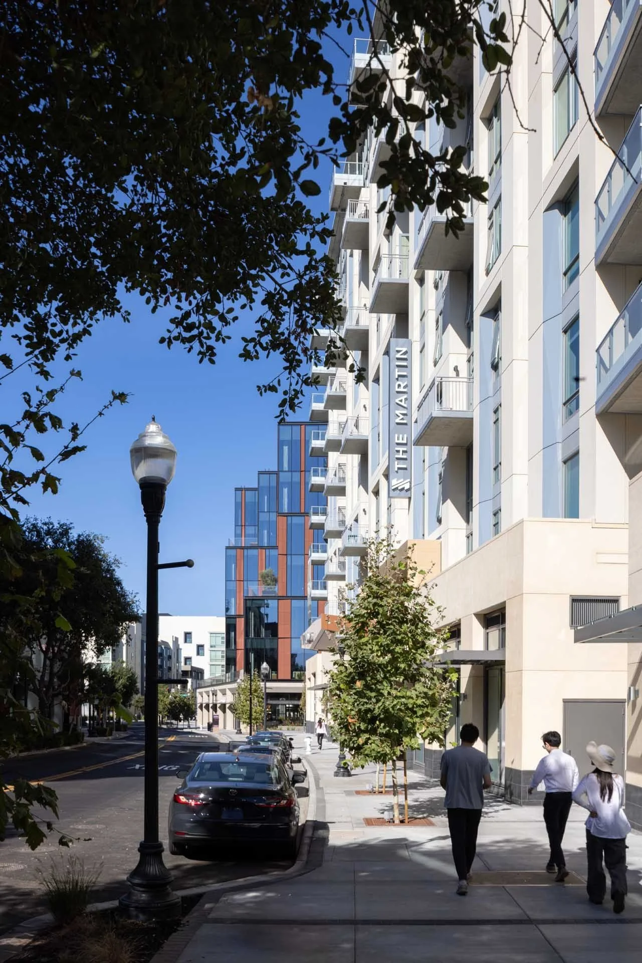 Tree-lined street with lamp posts beside the residential buildings at CityLine, The Martin, Sunnyvale