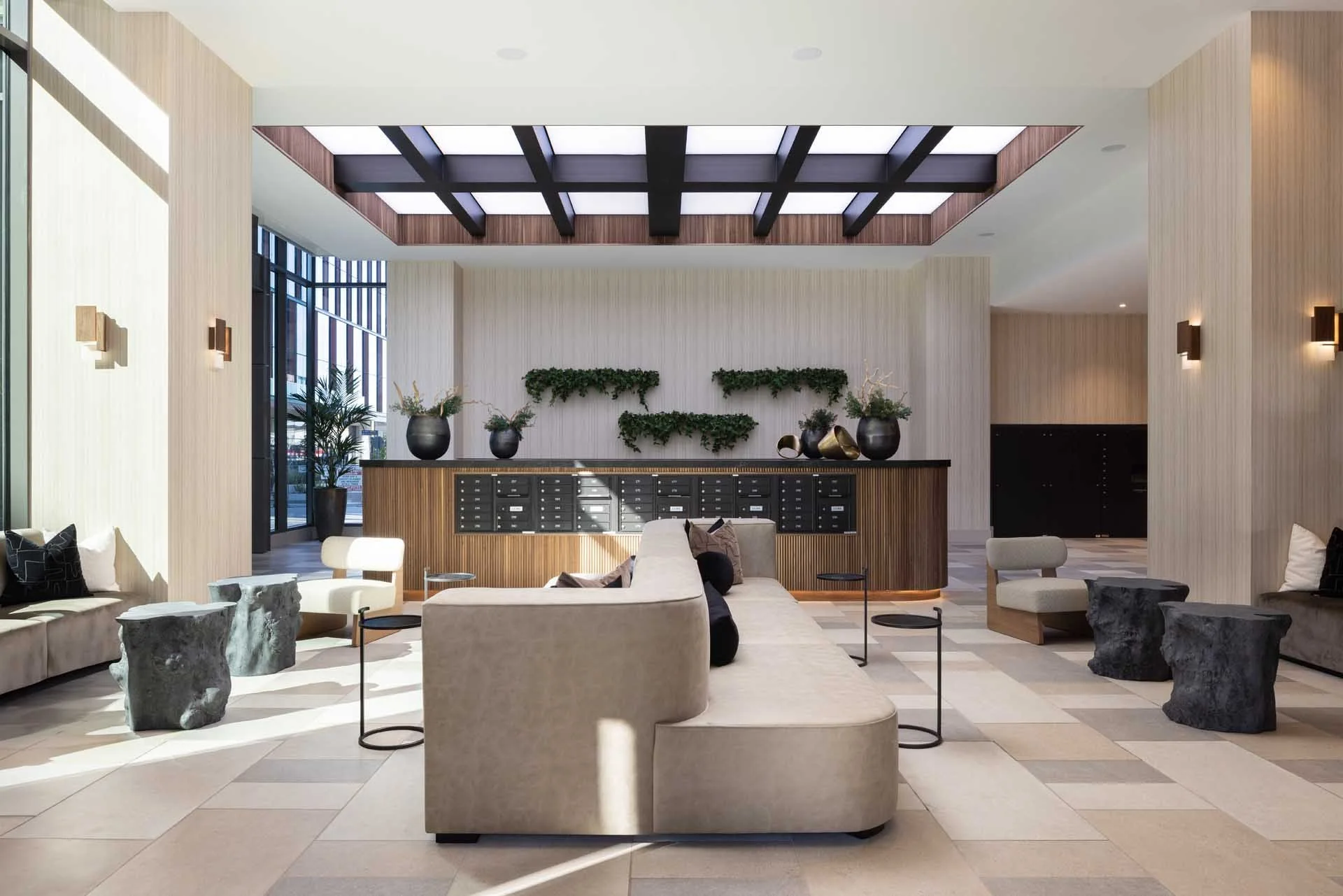 Resident lounge with a curved sofa, skylight and plant wall, The Martin at CityLine, Sunnyvale