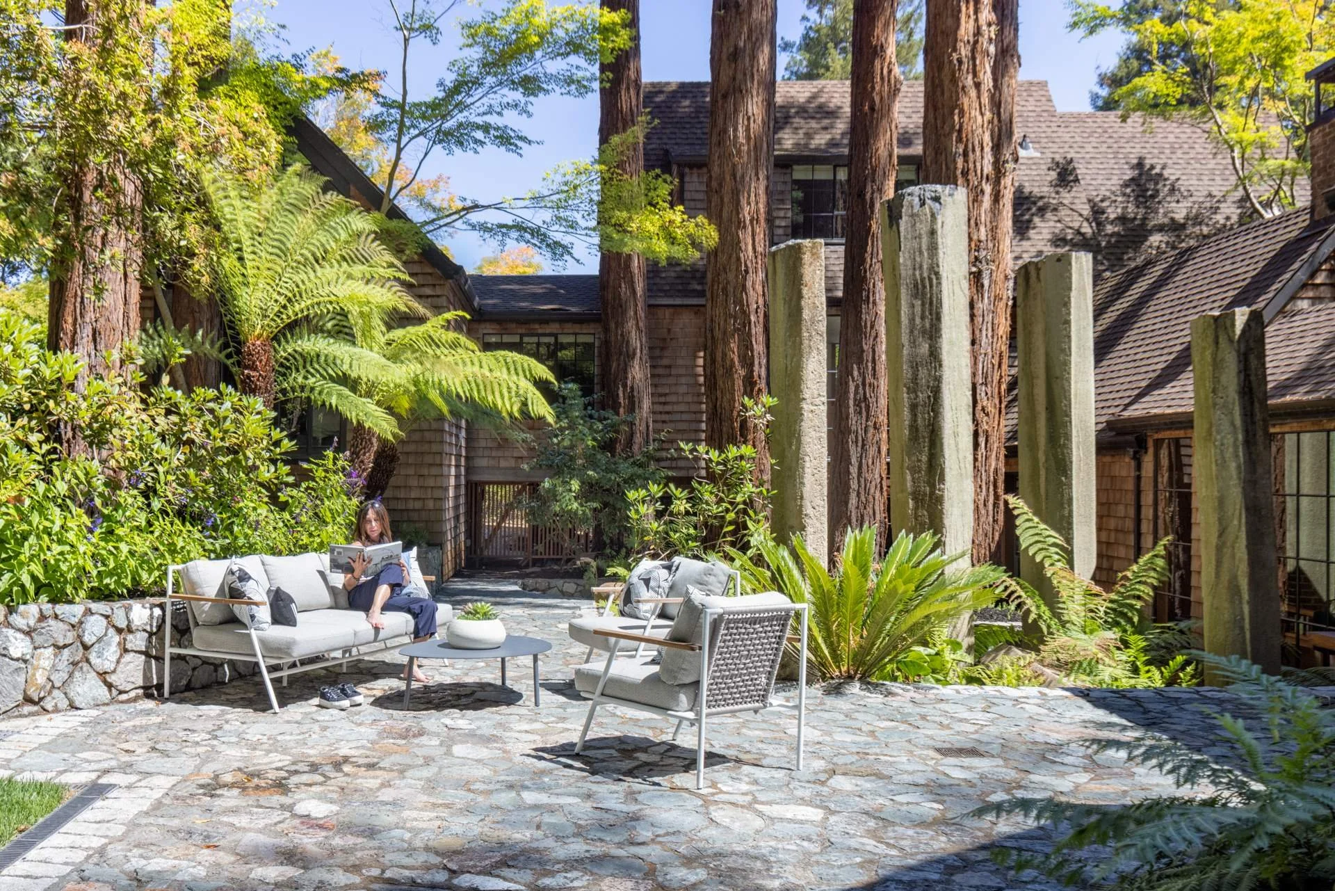 Flagstone patio with outdoor seating, ferns and redwood trunks, 16 Woodside, Mill Valley