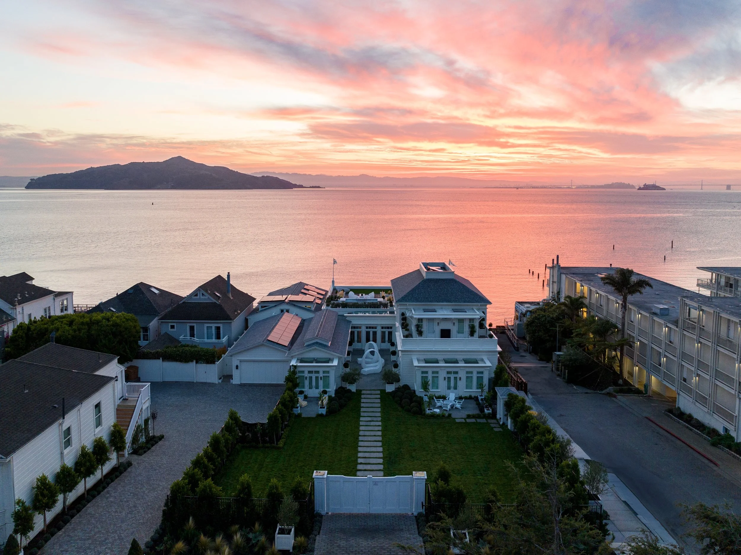 Aerial at sunrise over Valhalla and the Sausalito waterfront with Angel Island and the bay beyond