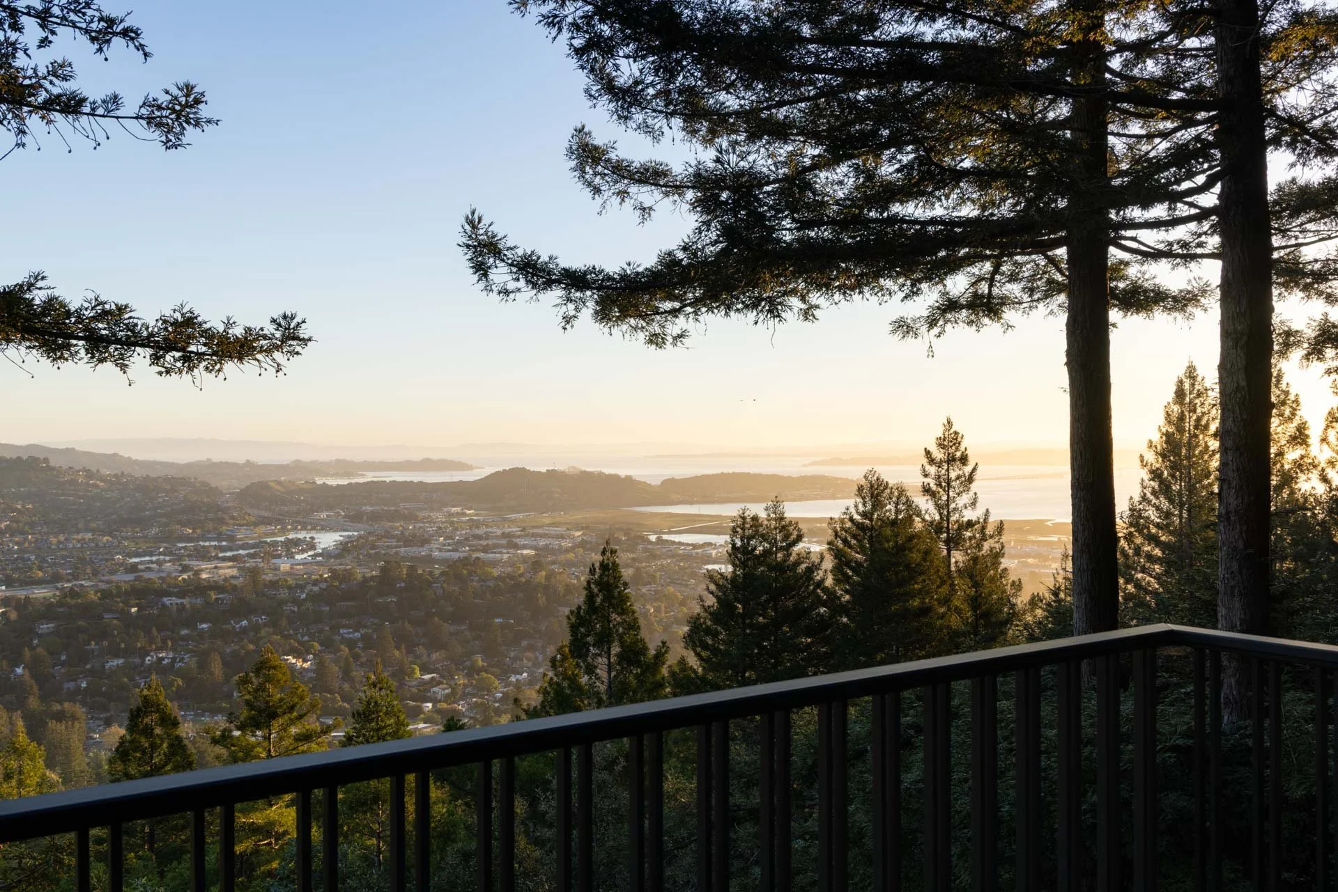 Deck view over the treetops to the Bay at sunset, 238 Summit Drive, Corte Madera