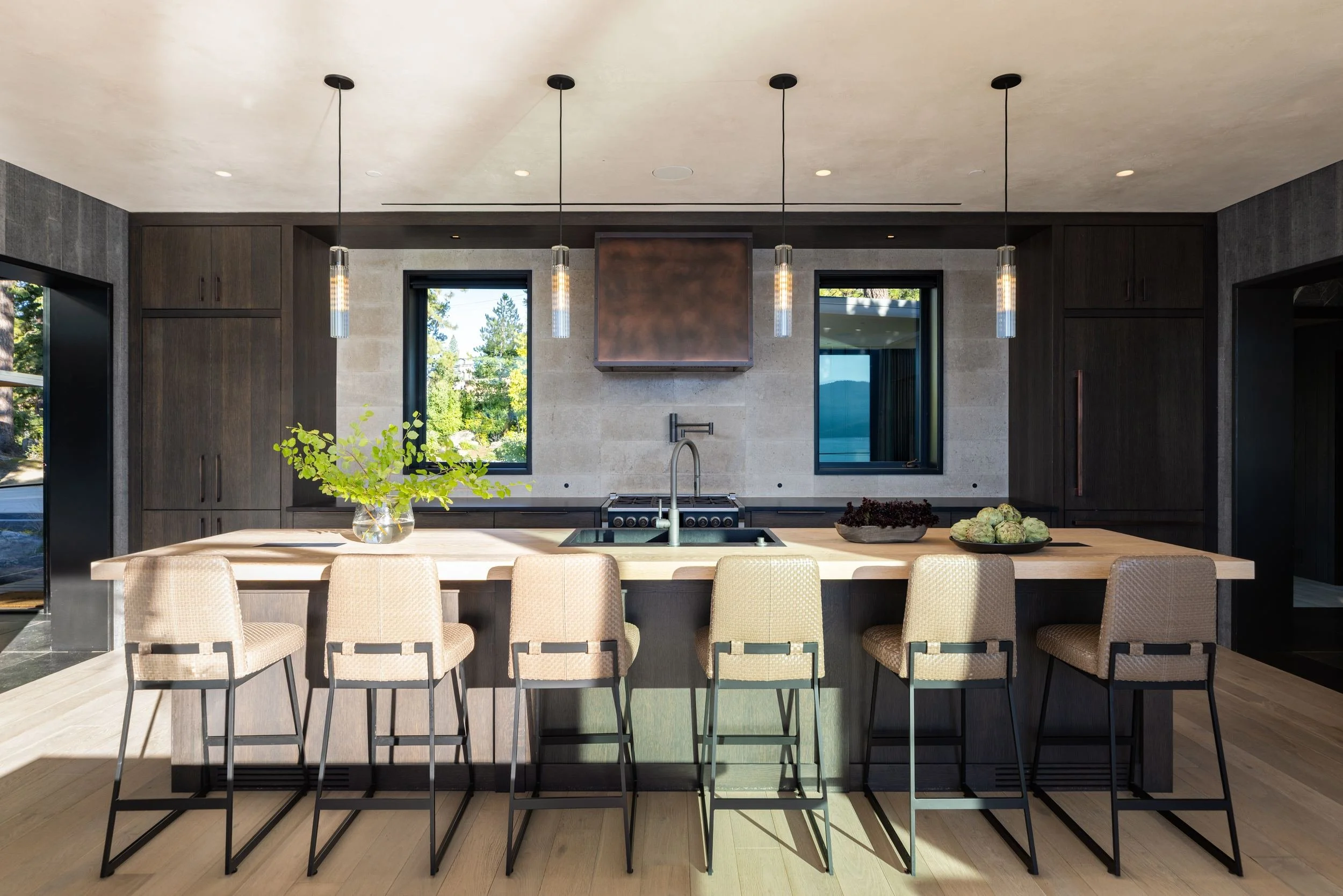 Kitchen island with glass pendants and dark wood cabinetry, Lake Tahoe Residence