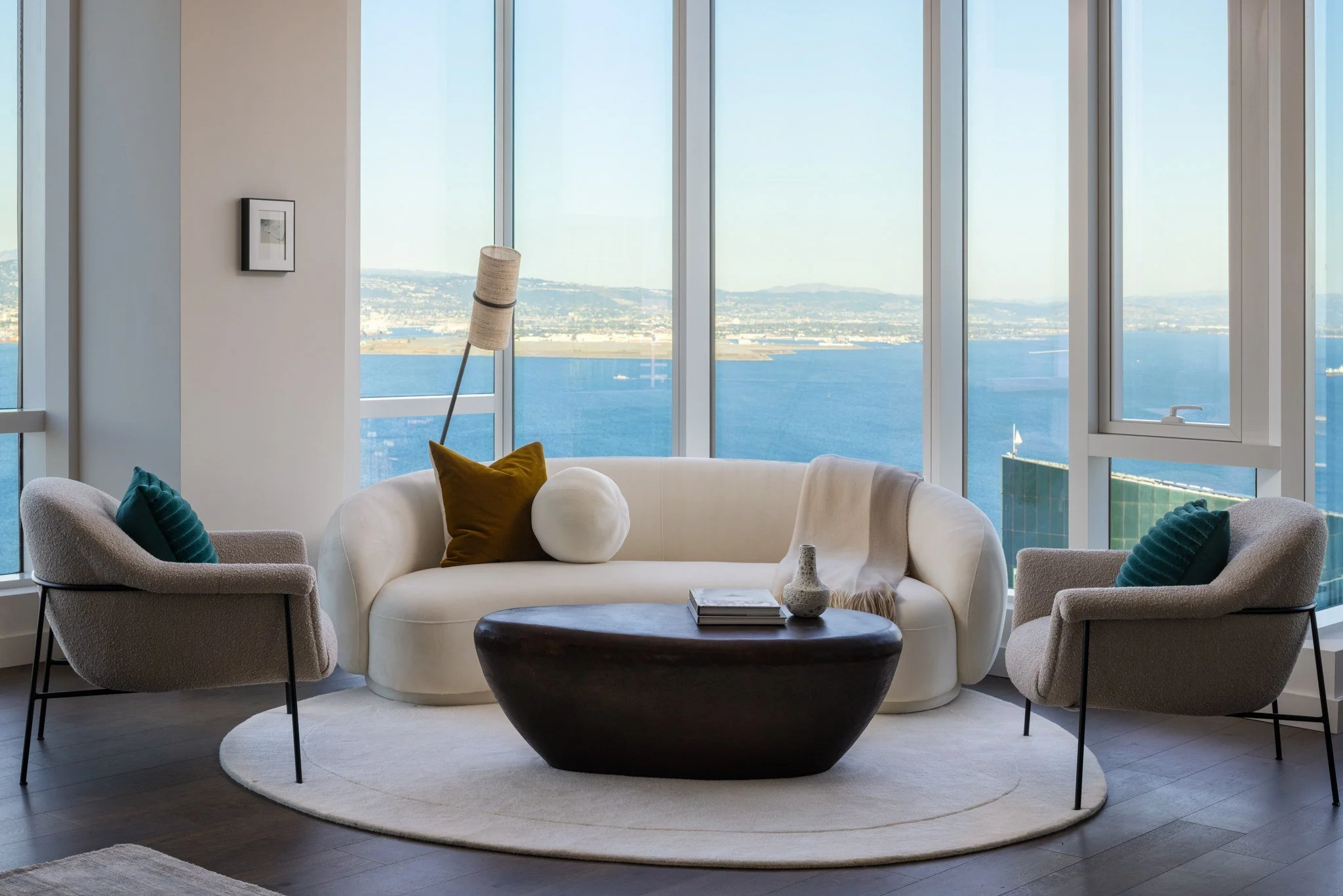 Penthouse lounge with curved sofa and Bay views, The Avery, San Francisco