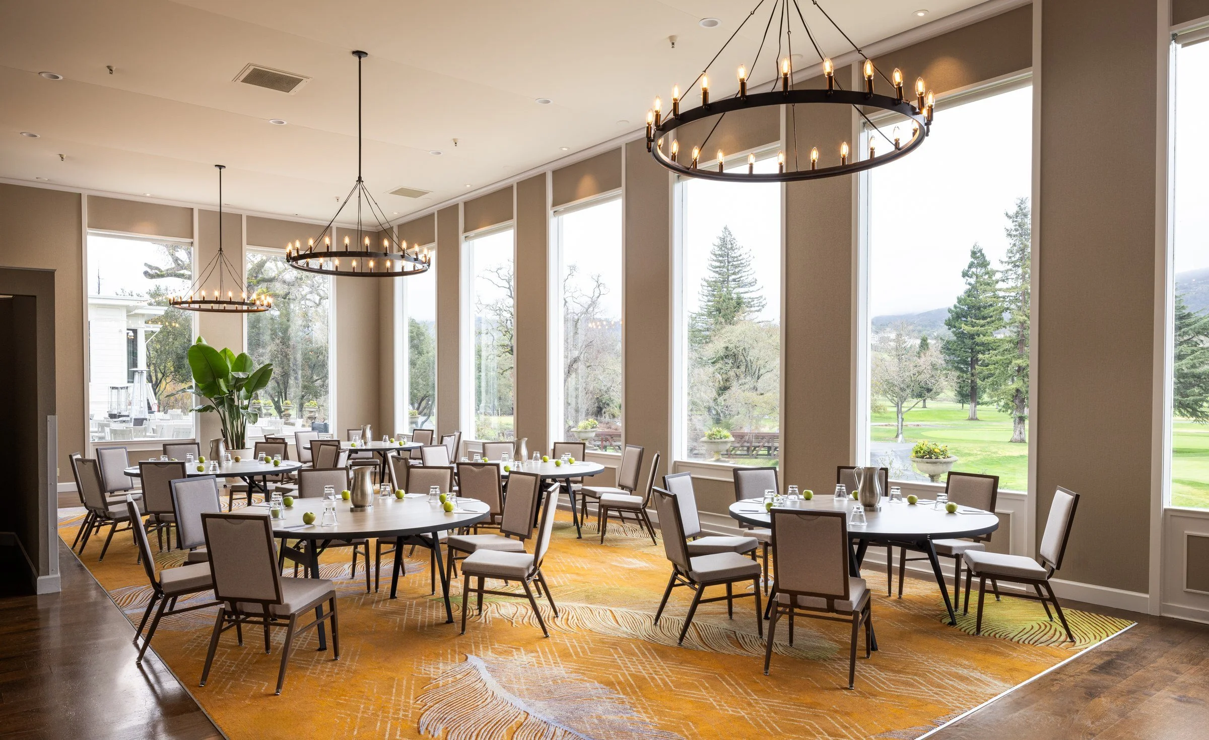 Ballroom set for a banquet beneath iron chandeliers, windows onto the golf course, Silverado Resort, Napa