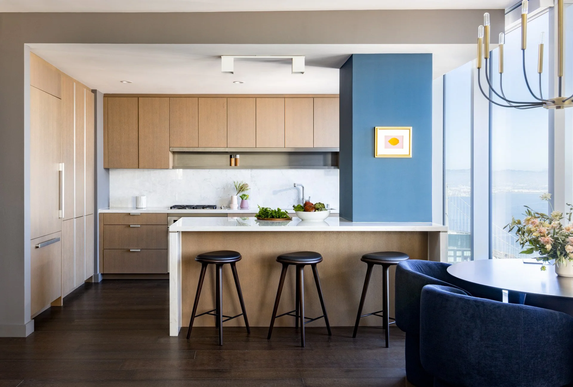 Open kitchen with walnut cabinetry and island, The Avery, San Francisco