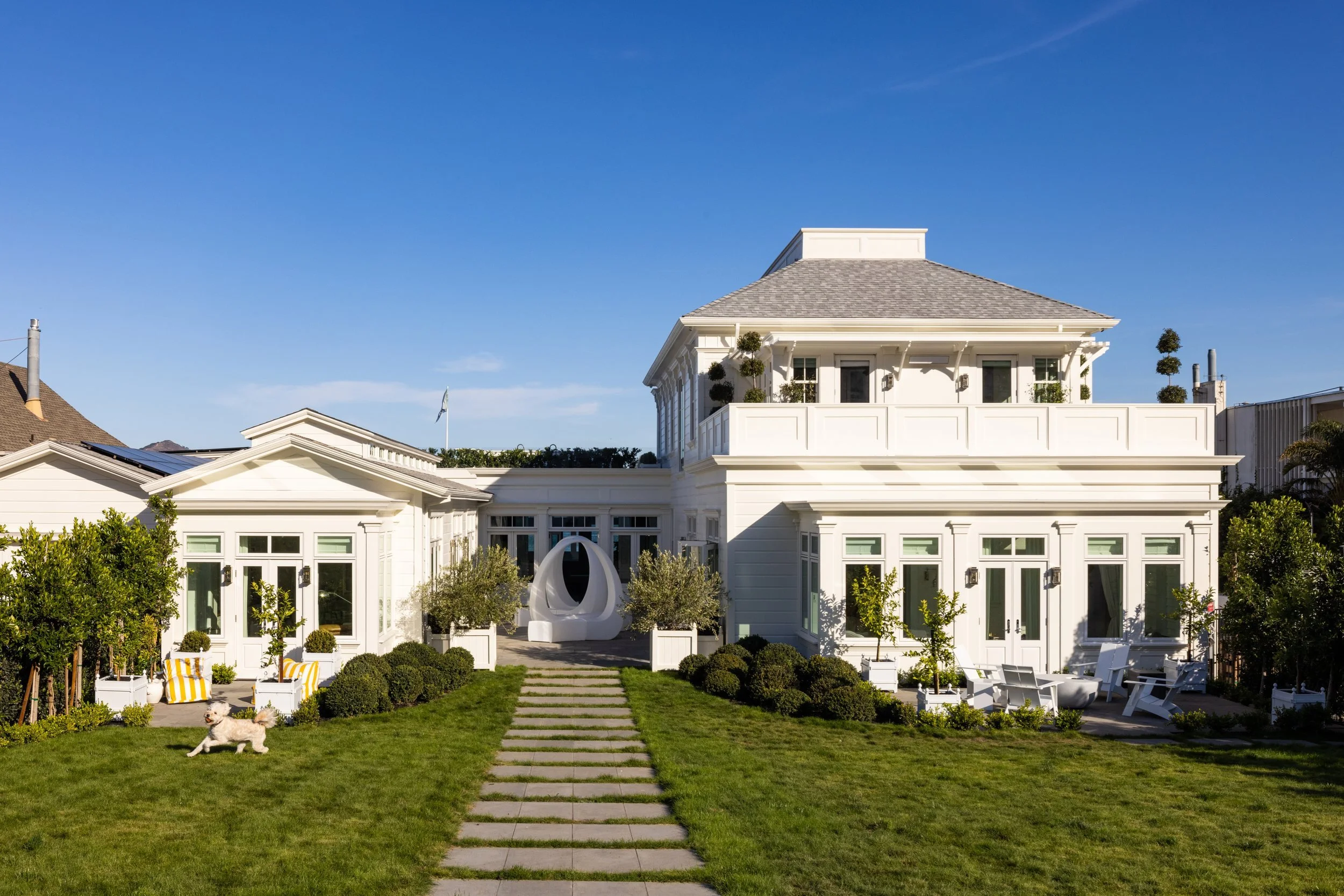 Front lawn and stepping-stone path to the white two-story house and its rooftop terrace, Valhalla, Sausalito