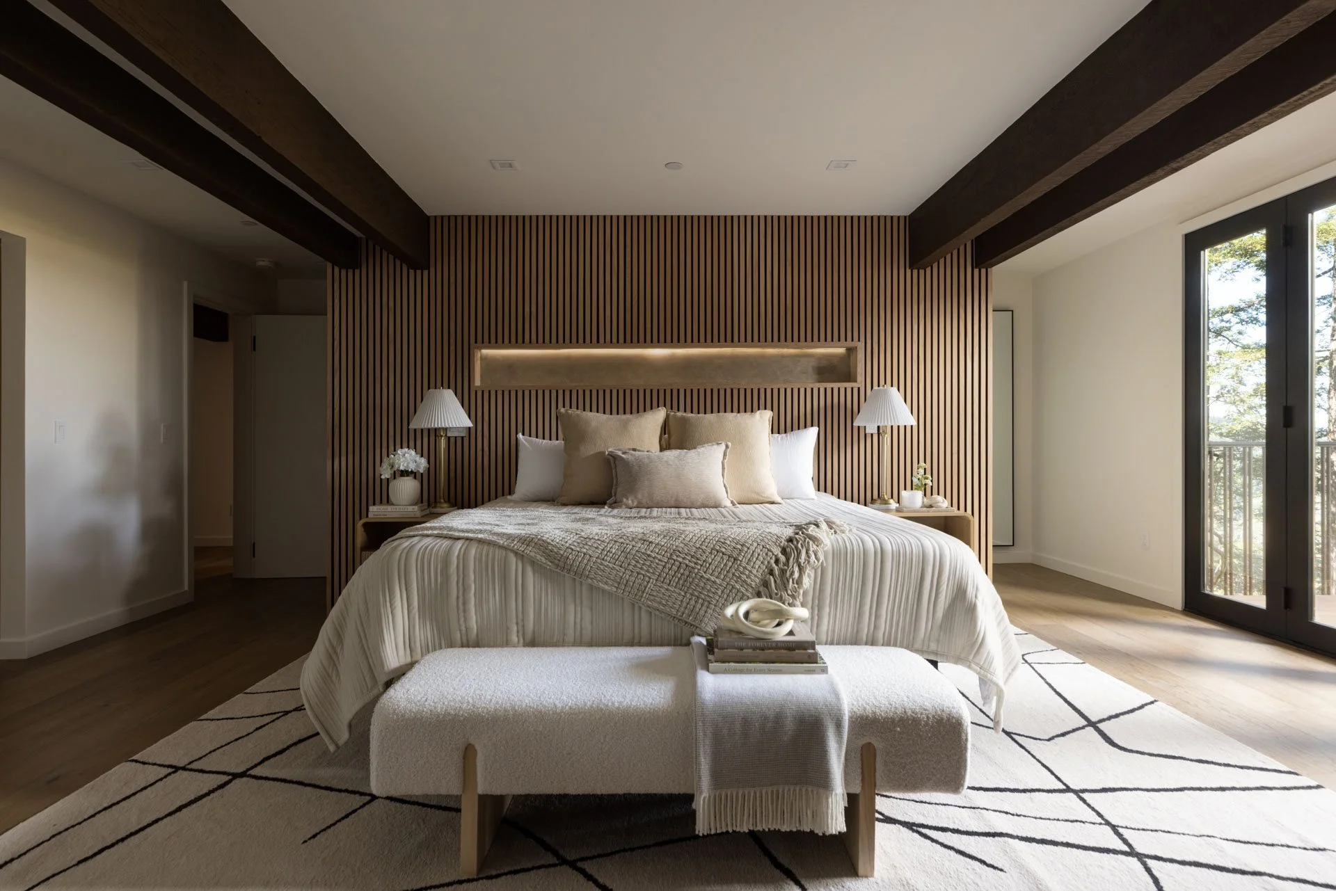 Primary bedroom with a slatted wood headboard wall and dark timber beams, 238 Summit Drive, Corte Madera
