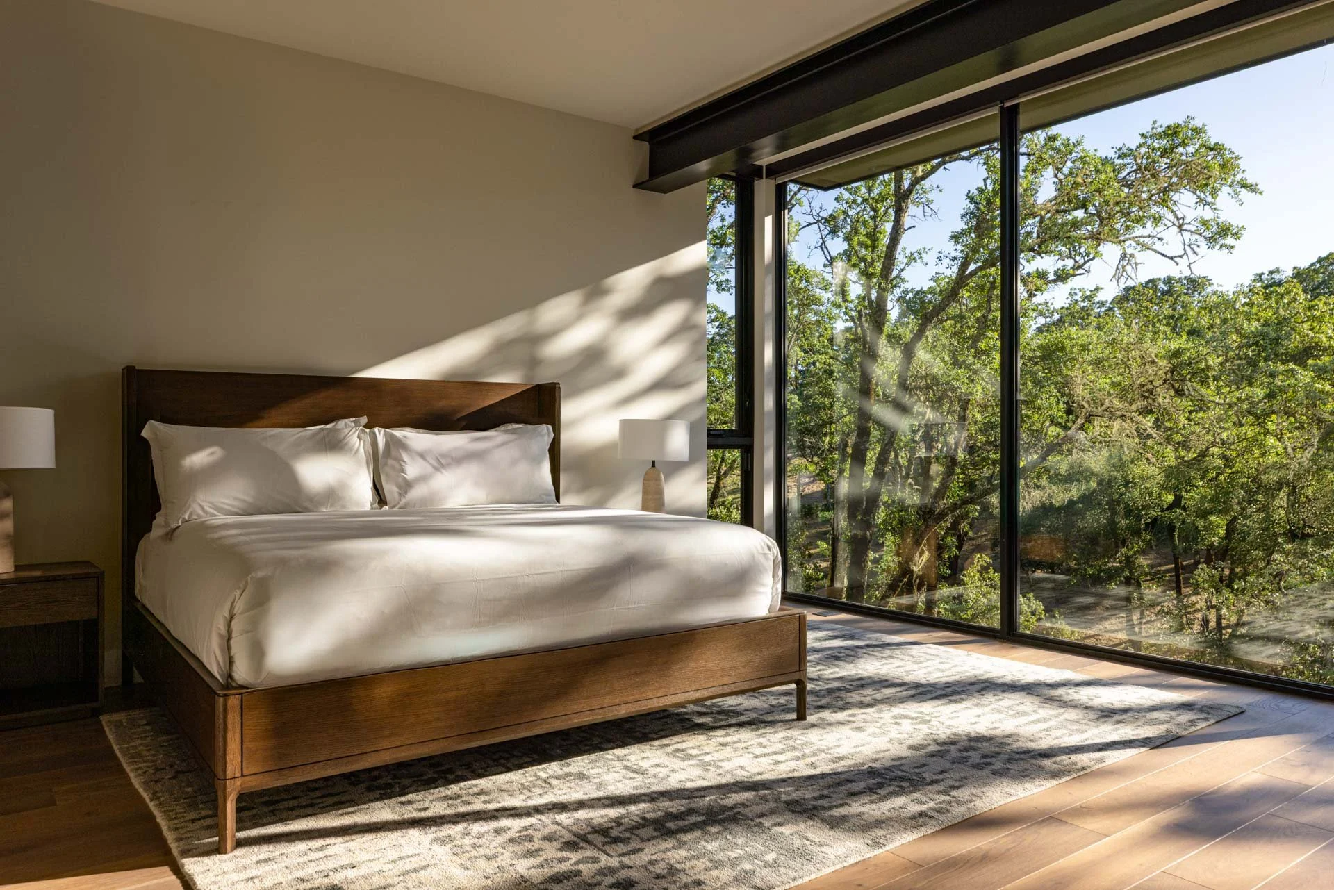 Guest bedroom opening to the oak woodland, a resort residence at Montage Healdsburg