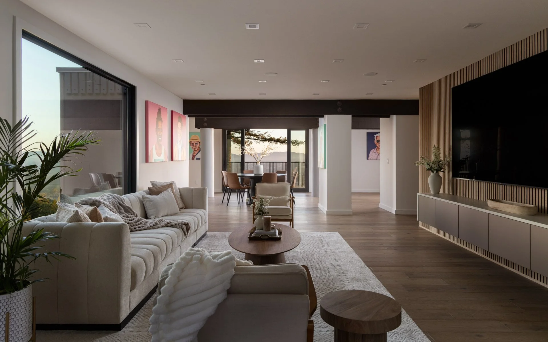 Open living room with cream sofas flowing to the dining area and treetop views, 238 Summit Drive, Corte Madera