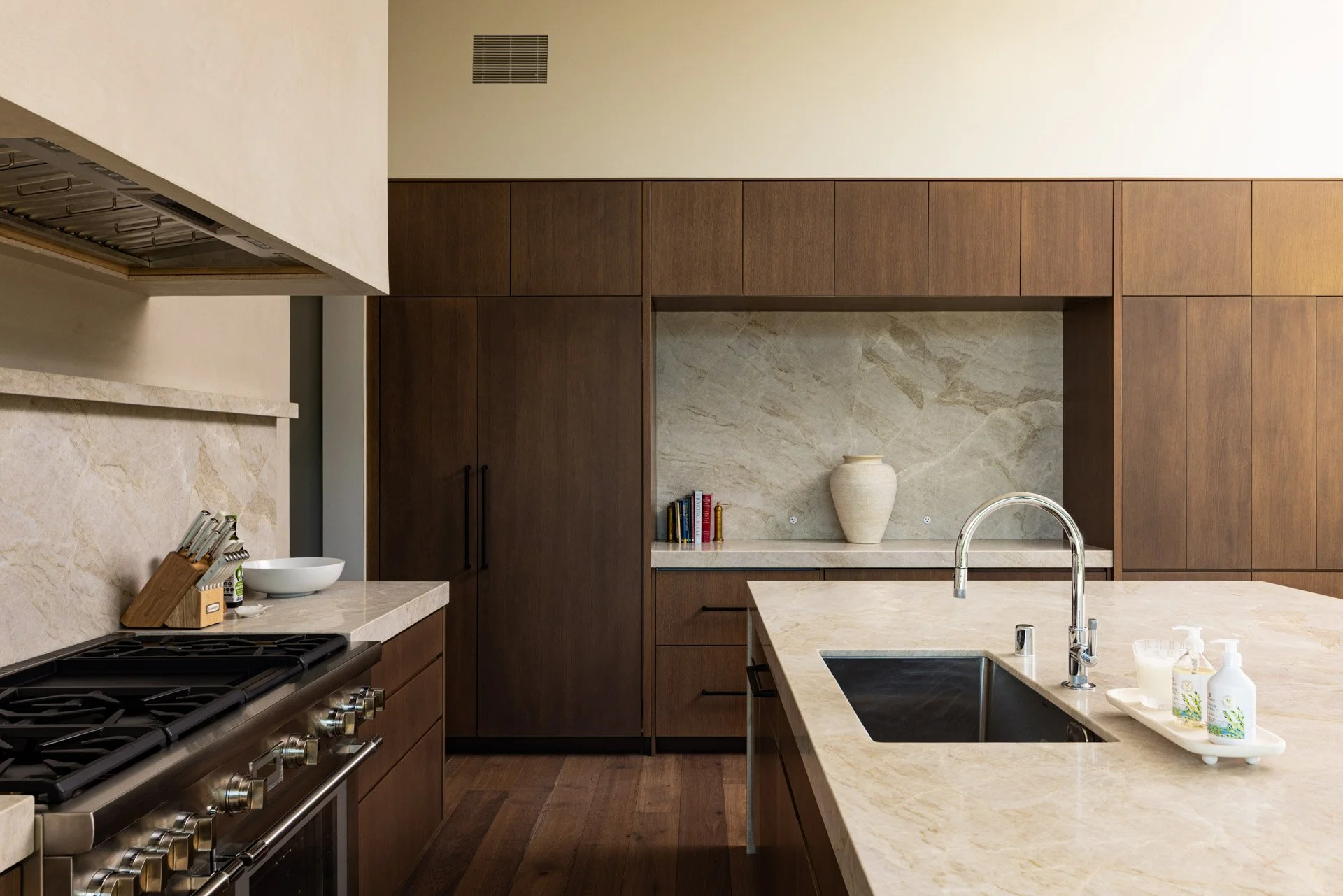 Kitchen with stone backsplash and walnut cabinetry, a resort residence at Montage Healdsburg