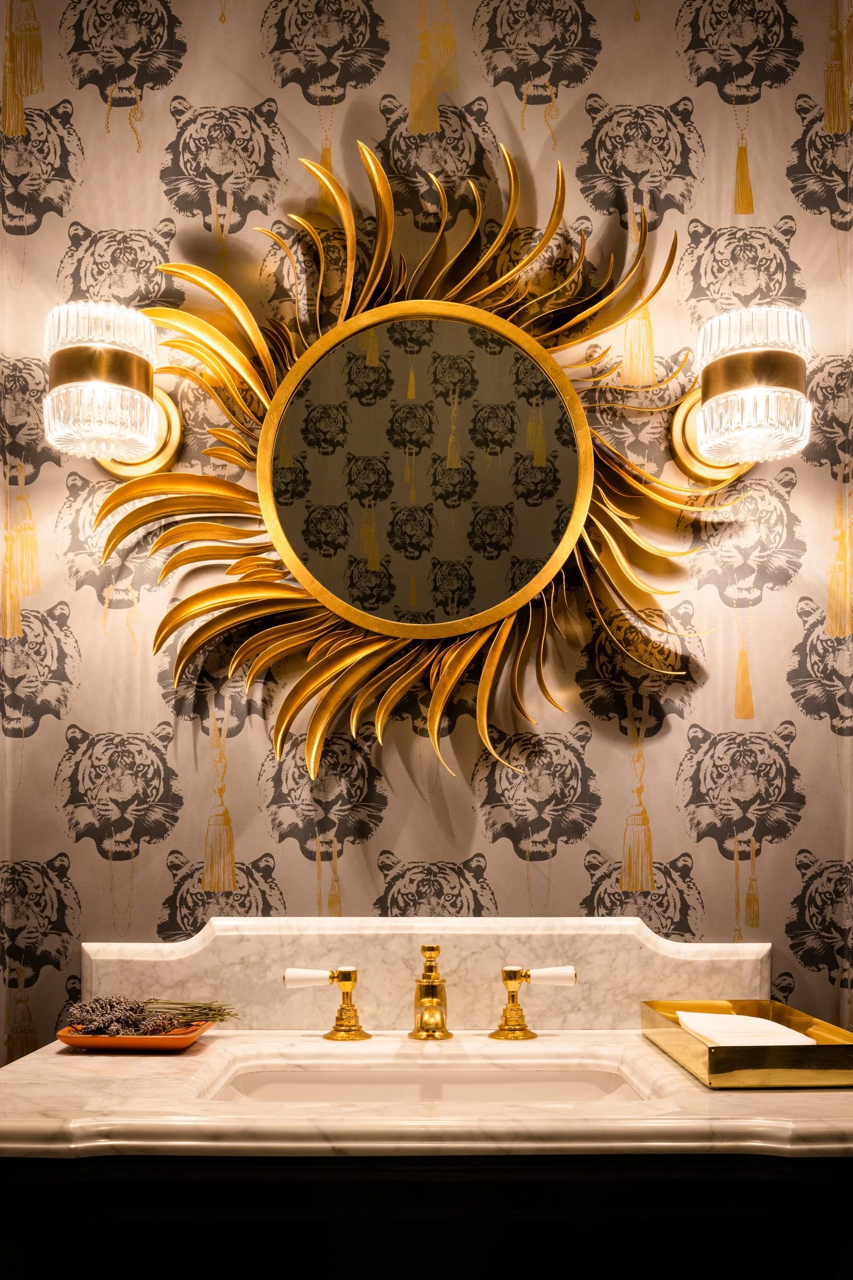 Powder room with a gilded sunburst mirror on patterned wallpaper over a marble vanity, Valhalla, Sausalito