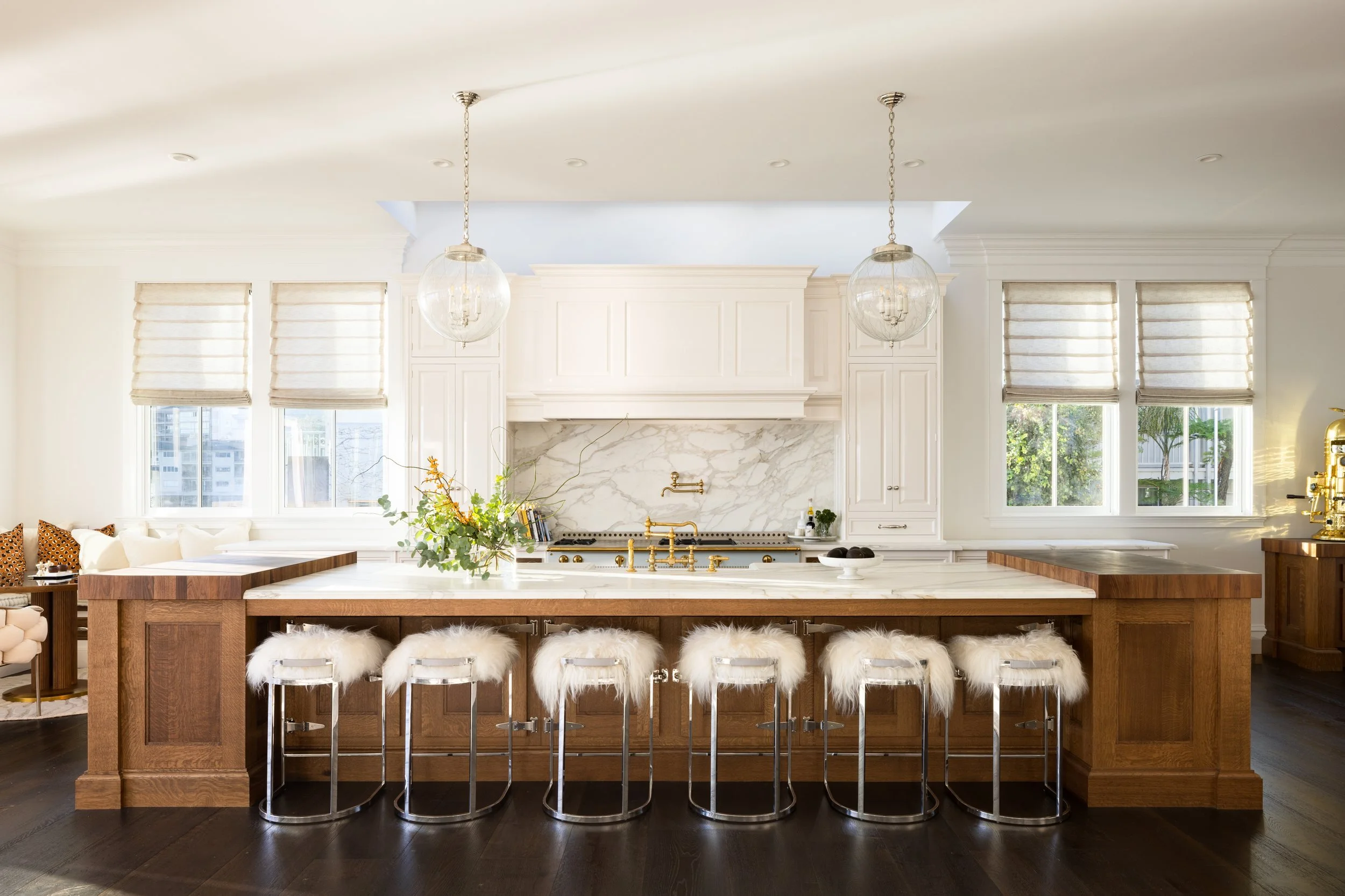 Kitchen with a walnut island, sheepskin counter stools and globe pendants under coffered ceilings, Valhalla, Sausalito