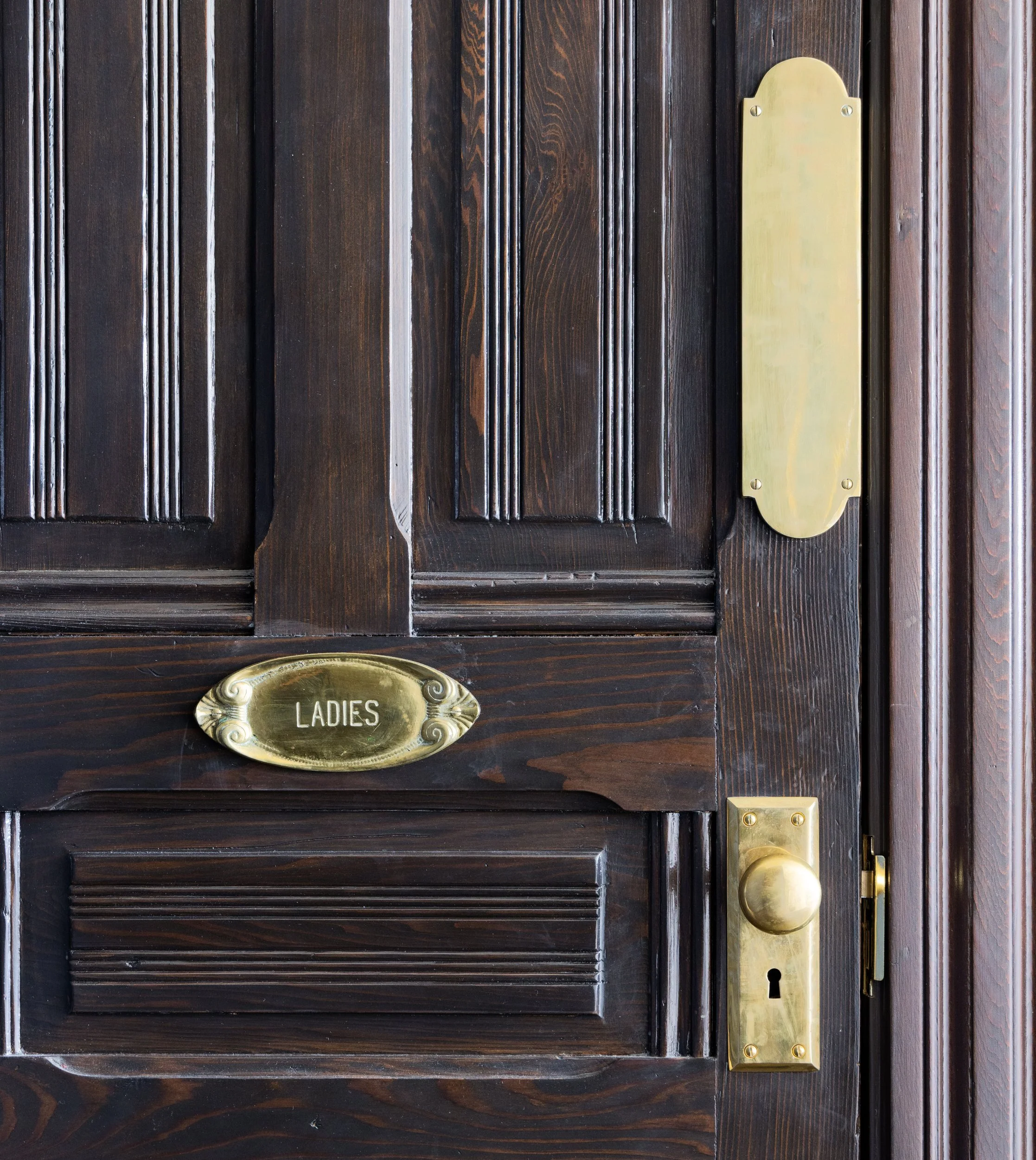 Original carved wood door with a brass Ladies plate, a relic of Sally Stanford's Valhalla restaurant, Sausalito