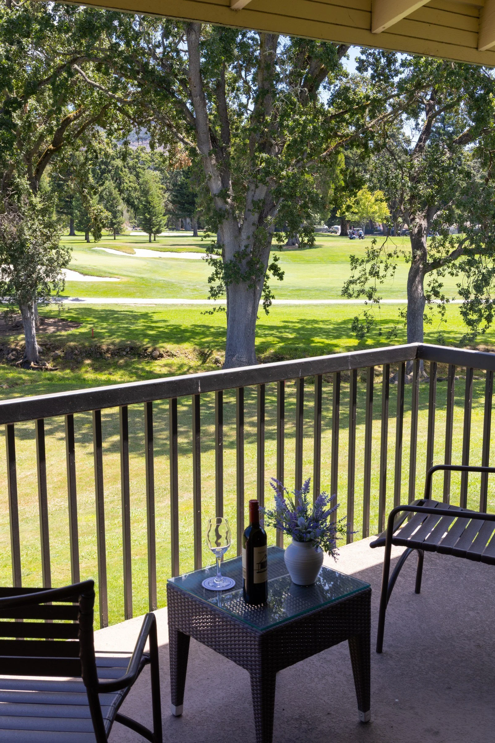 Suite balcony with wine and two chairs facing the golf course, Silverado Resort, Napa