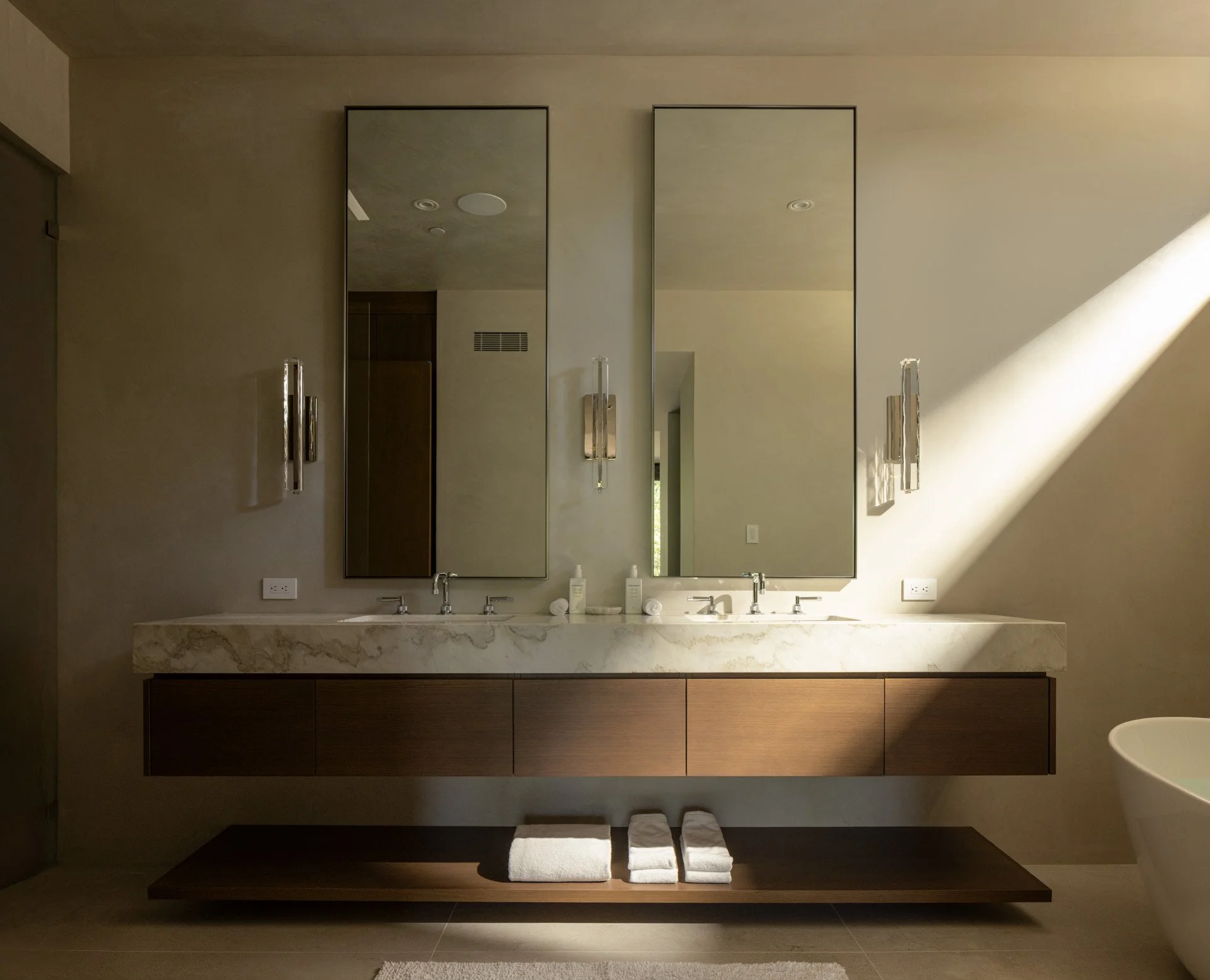 Floating stone vanity lit by afternoon sun, a resort residence at Montage Healdsburg