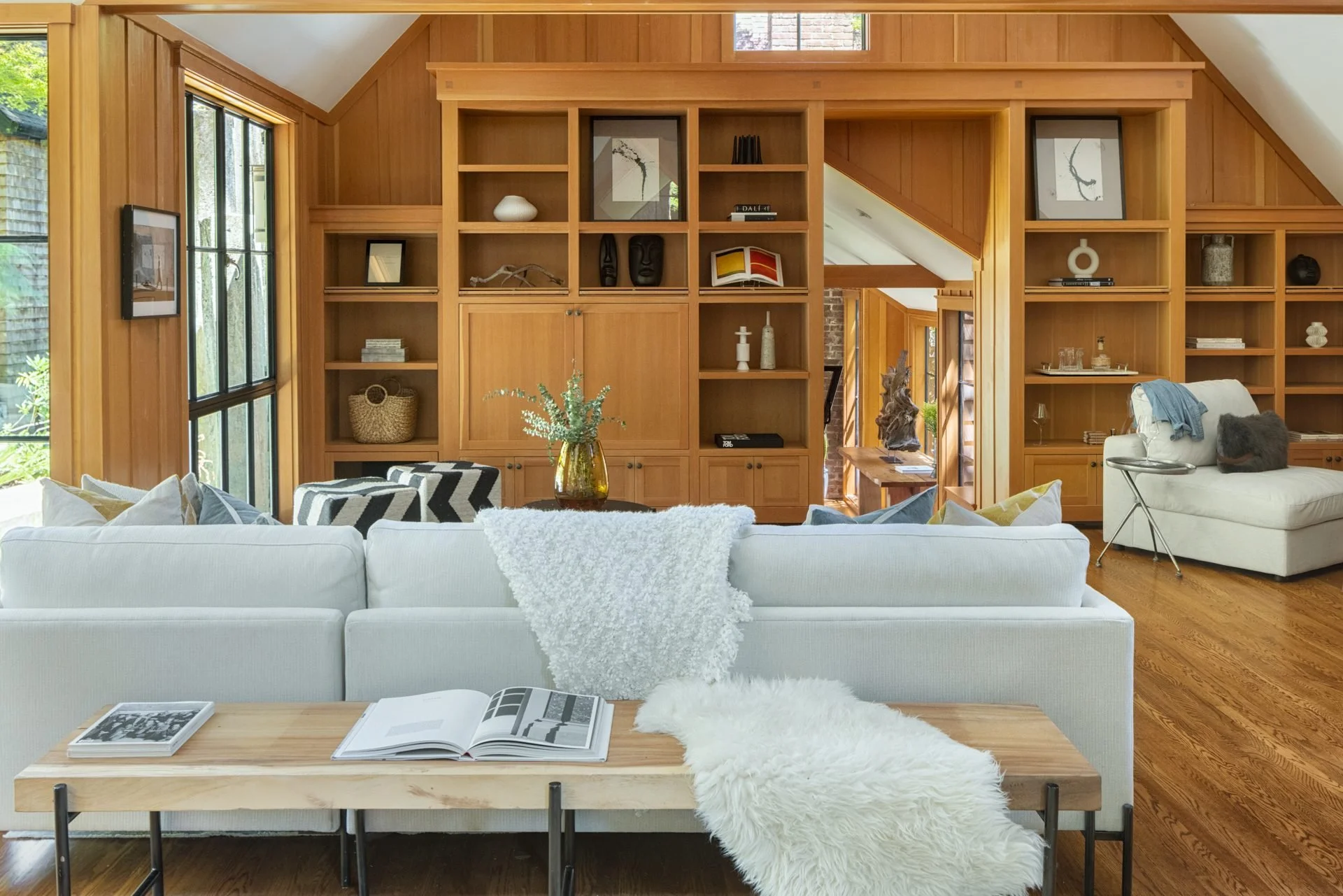 Wood-paneled family room with built-in shelving and a white sectional, 16 Woodside, Mill Valley