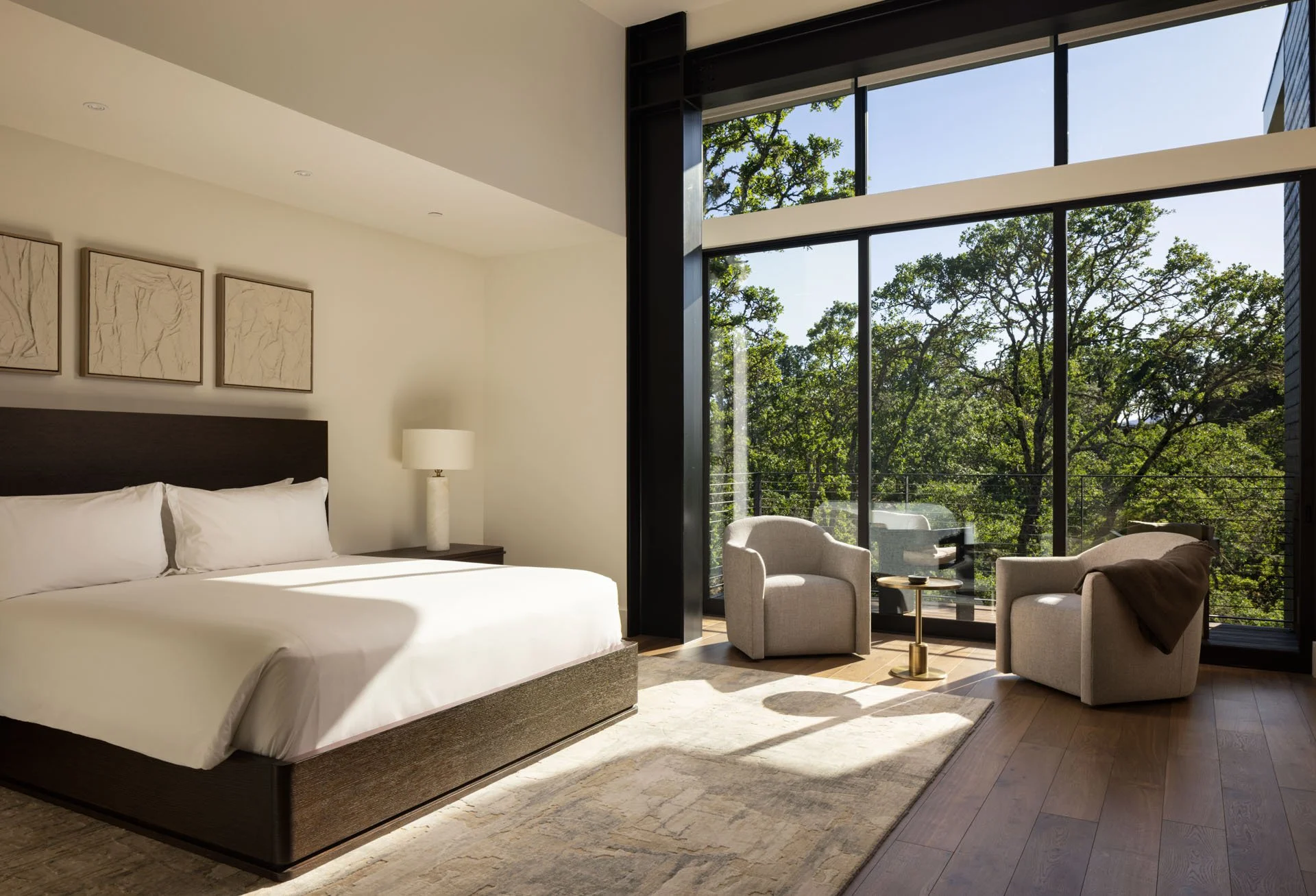 Primary bedroom with a wall of glass onto the oaks, a resort residence at Montage Healdsburg