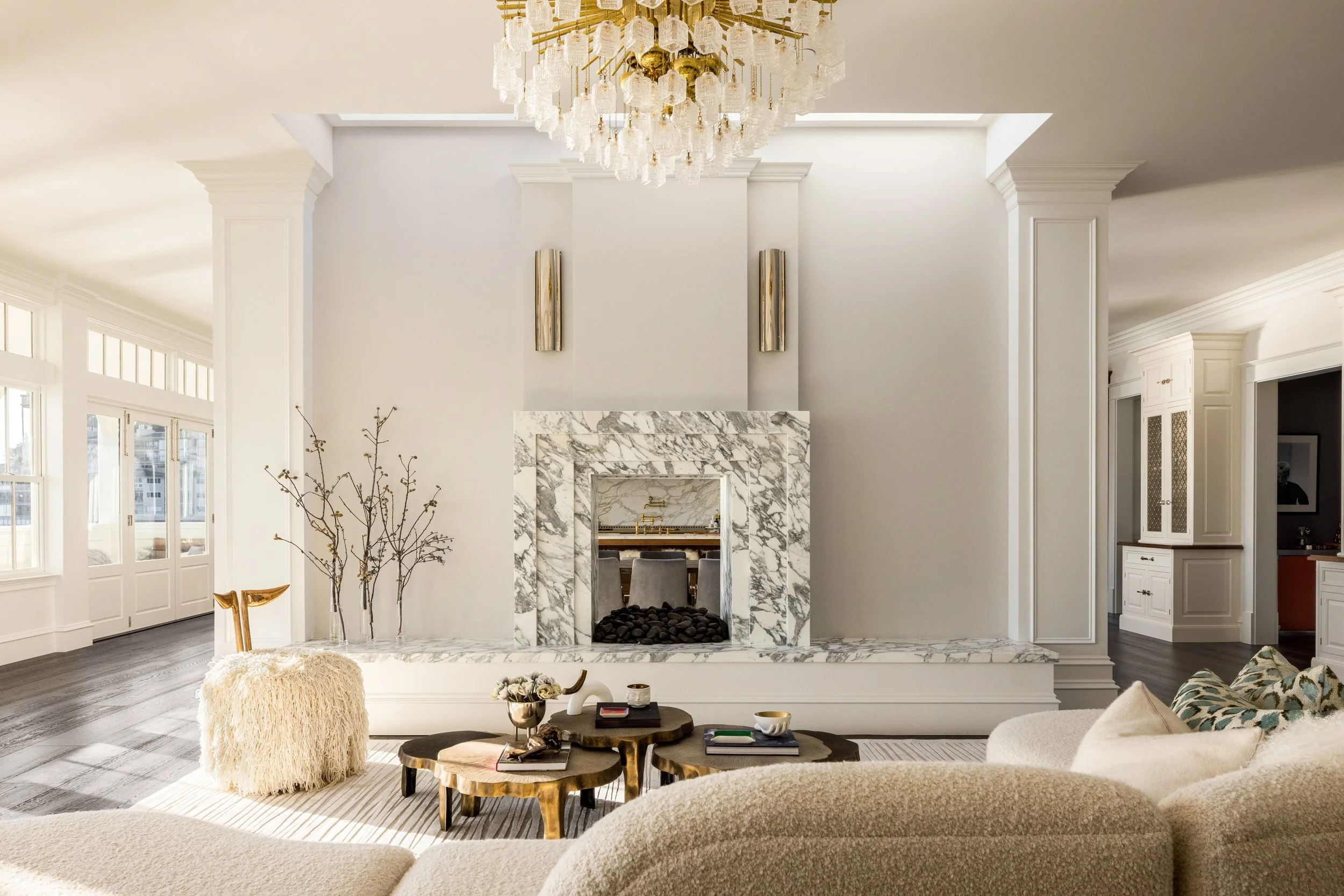 Living room with a Calacatta Viola marble fireplace, crystal chandelier and sheepskin seating, Valhalla, Sausalito