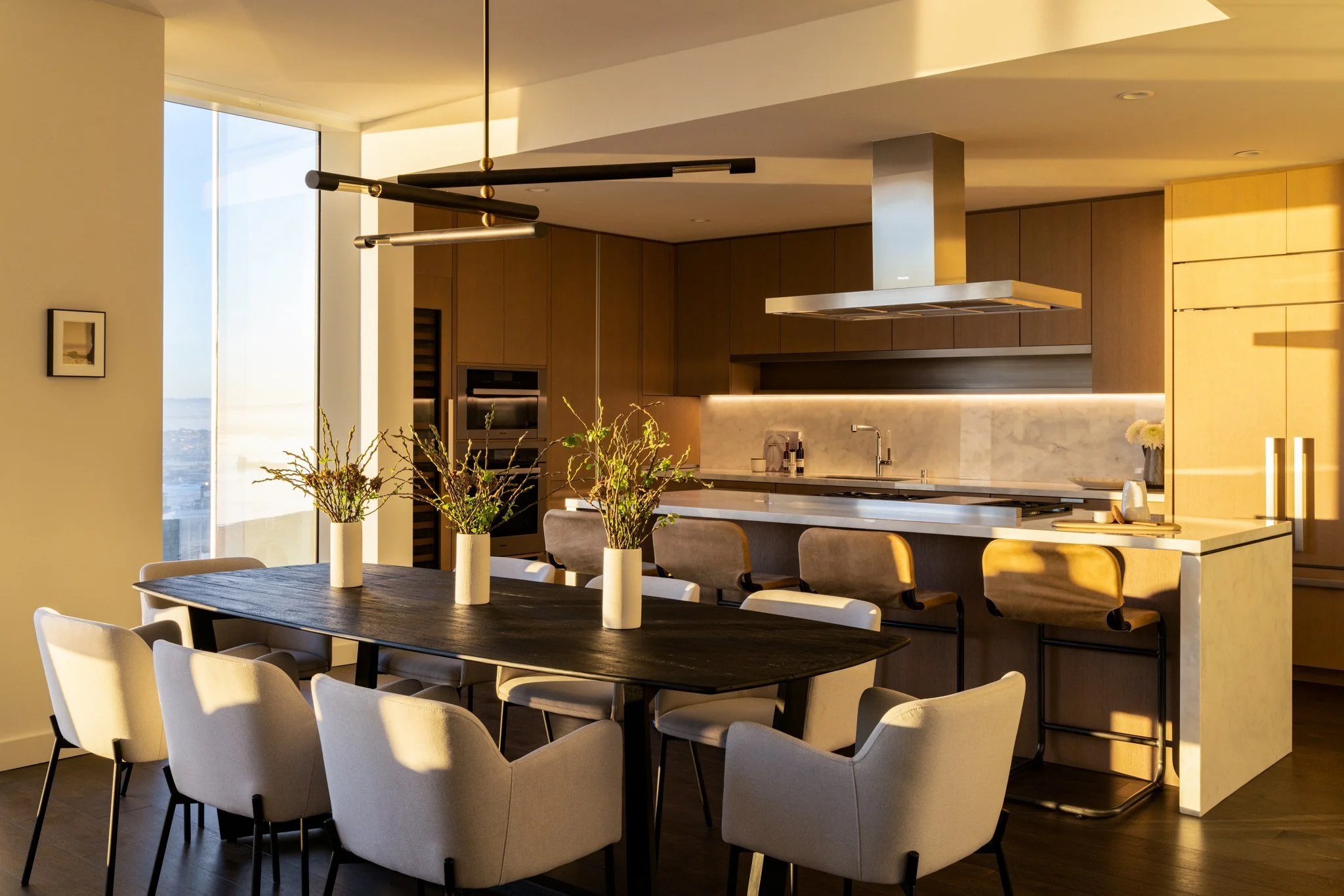 Penthouse kitchen and dining room at dusk, The Avery, San Francisco