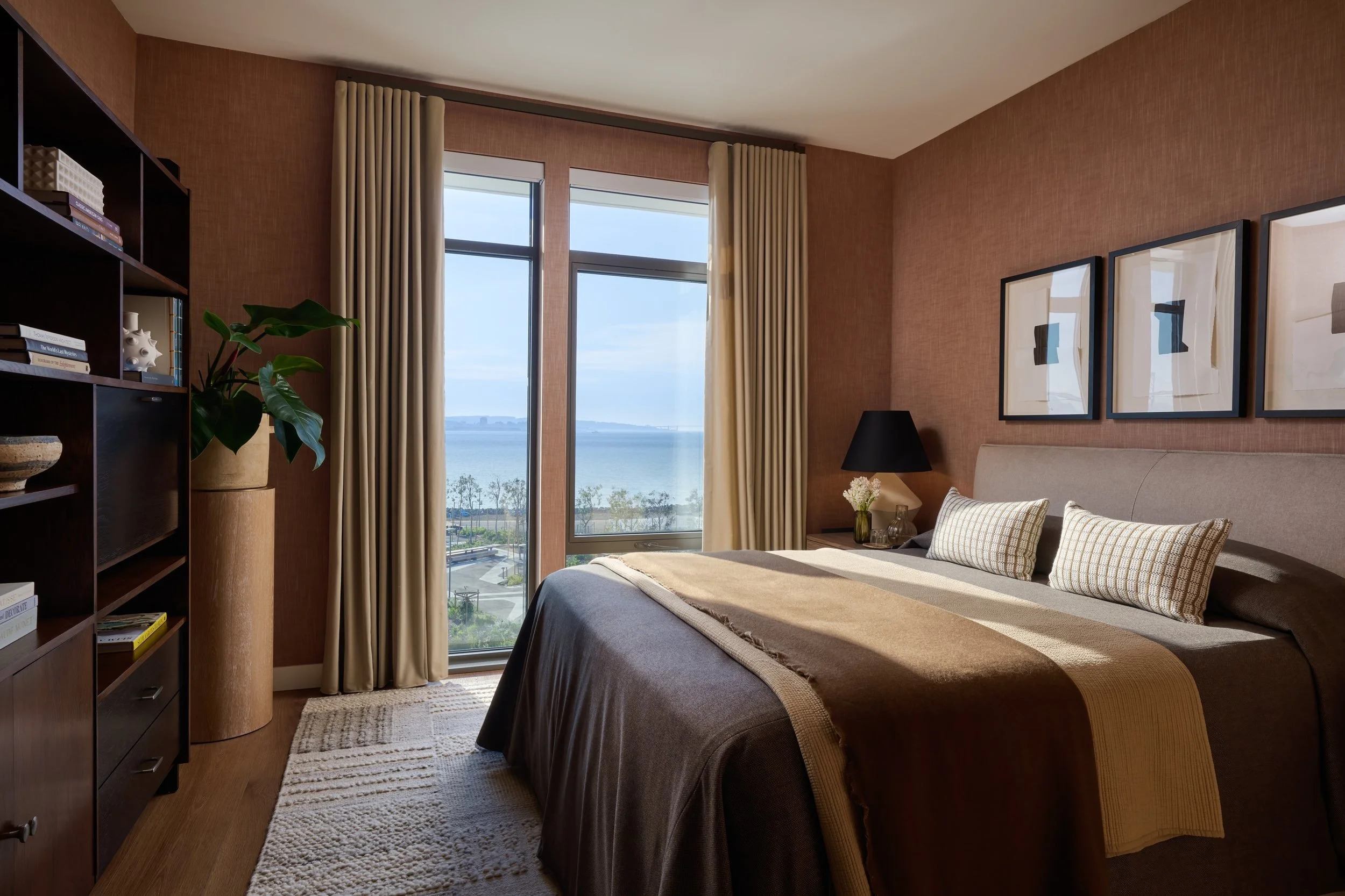 Model residence bedroom with brown drapery and a corner window onto the Bay, 490 Avenue of the Palms, Treasure Island