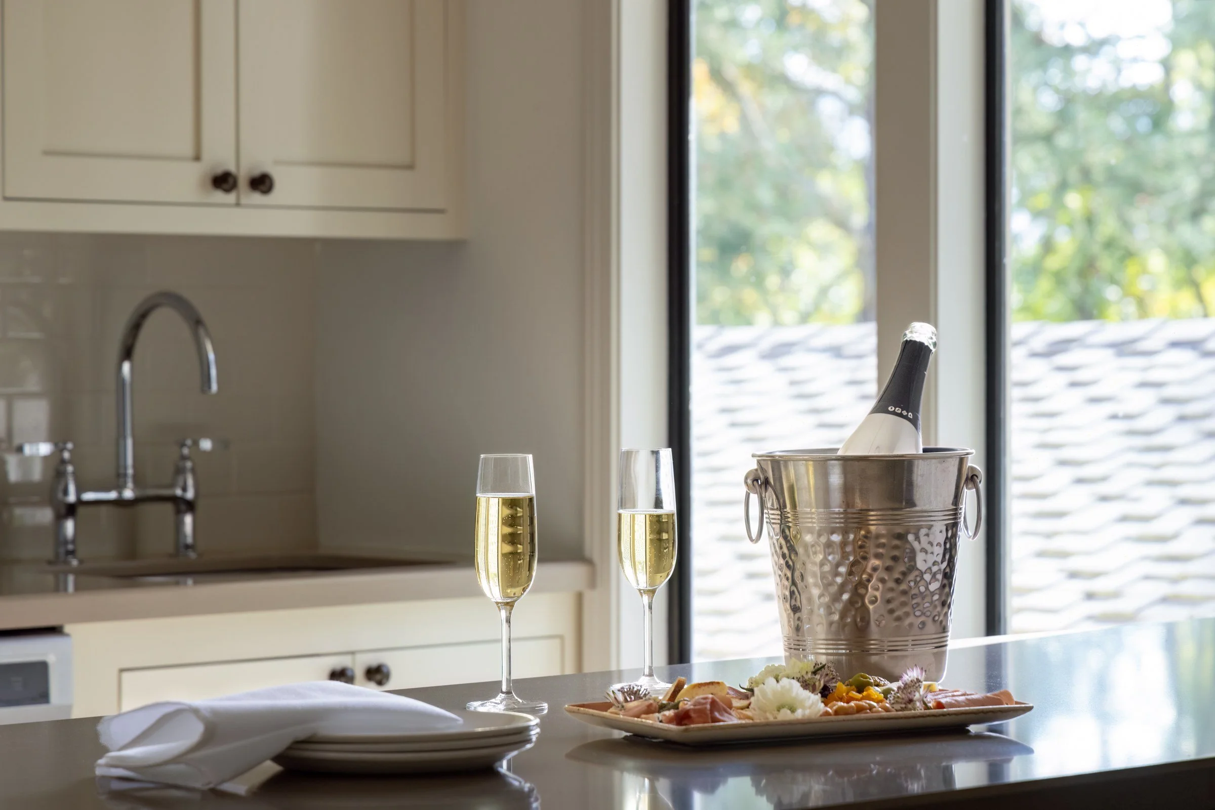 Suite kitchen with champagne and a cheese board by the window, Silverado Resort, Napa