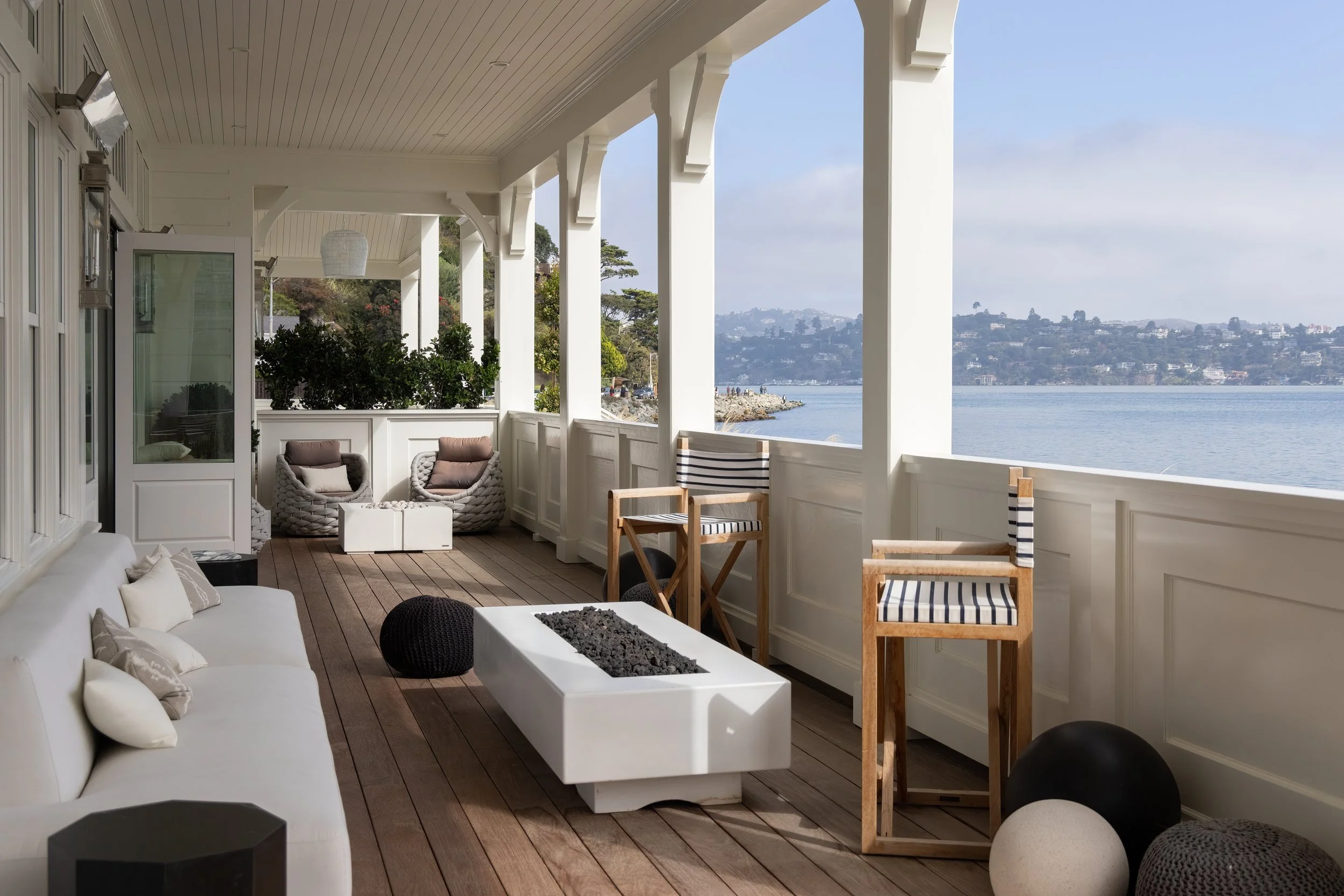 Covered veranda with a fire table and lounge seating looking across the water toward San Francisco, Valhalla, Sausalito