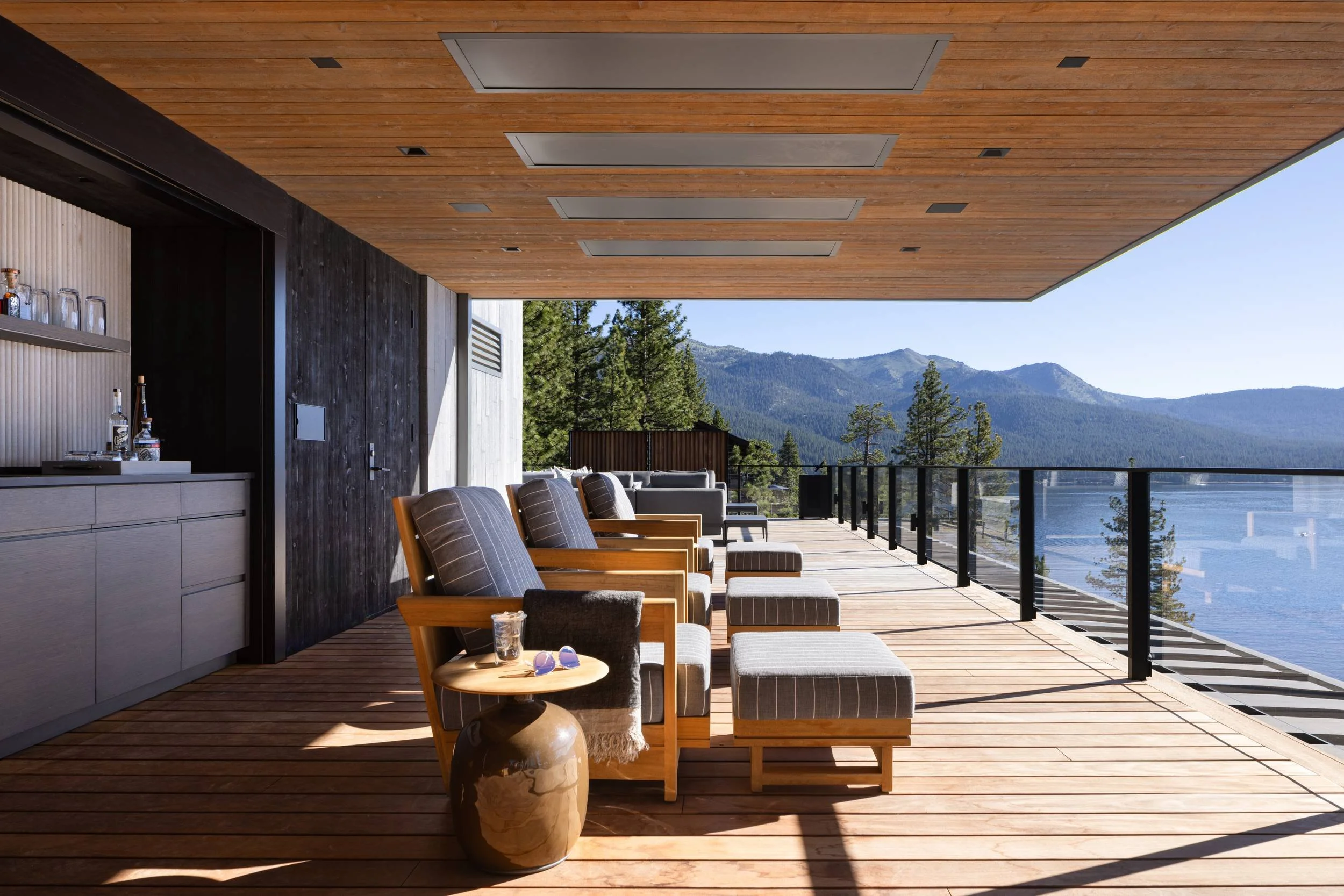 Covered deck with lounge chairs, outdoor bar and mountain views, Lake Tahoe Residence