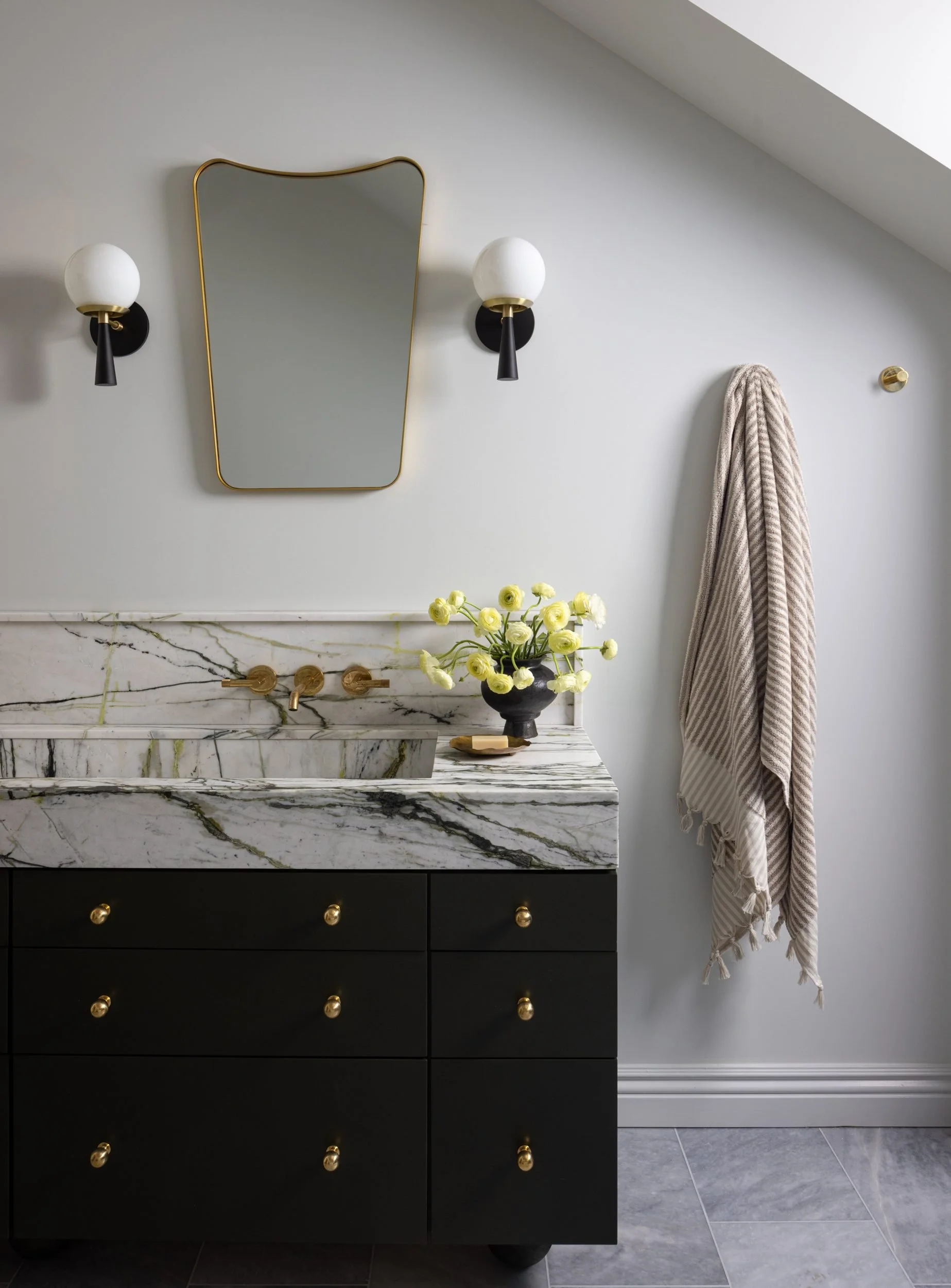 Black vanity with marble top, brass mirror and globe sconces, 99 Bosworth, Barlow Design