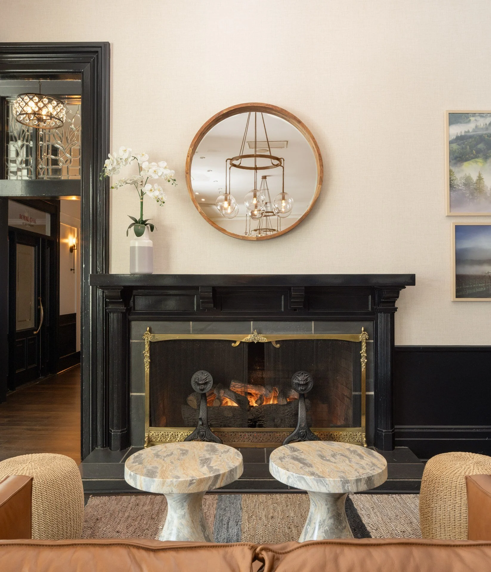 Black marble fireplace and round mirror in the mansion lounge, Silverado Resort, Napa
