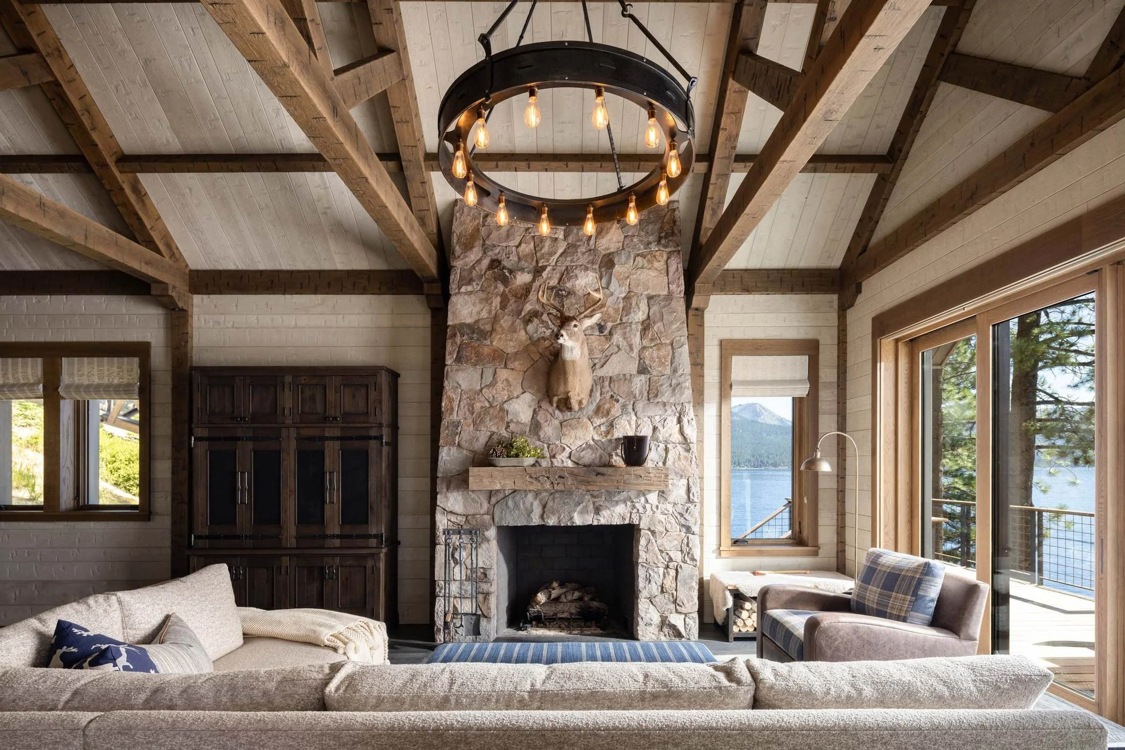 Lakeside cabin great room with stone fireplace and timber trusses, Lake Tahoe Residence