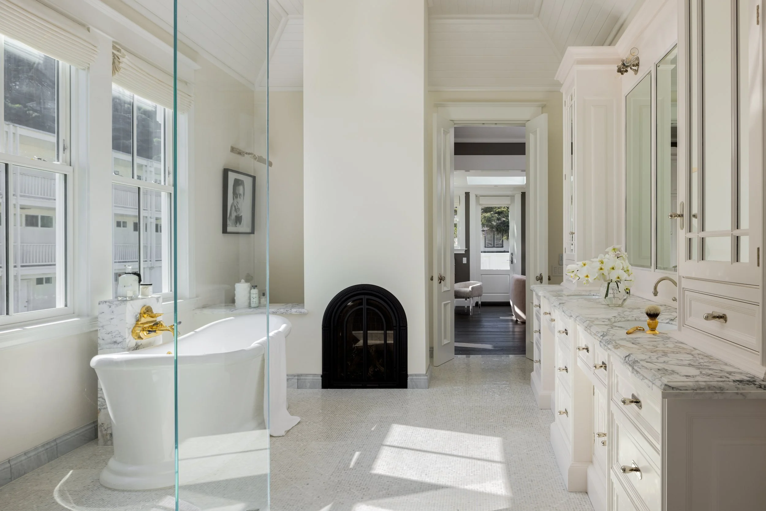 Primary bath with a freestanding tub, glass shower and arched fireplace in white marble, Valhalla, Sausalito