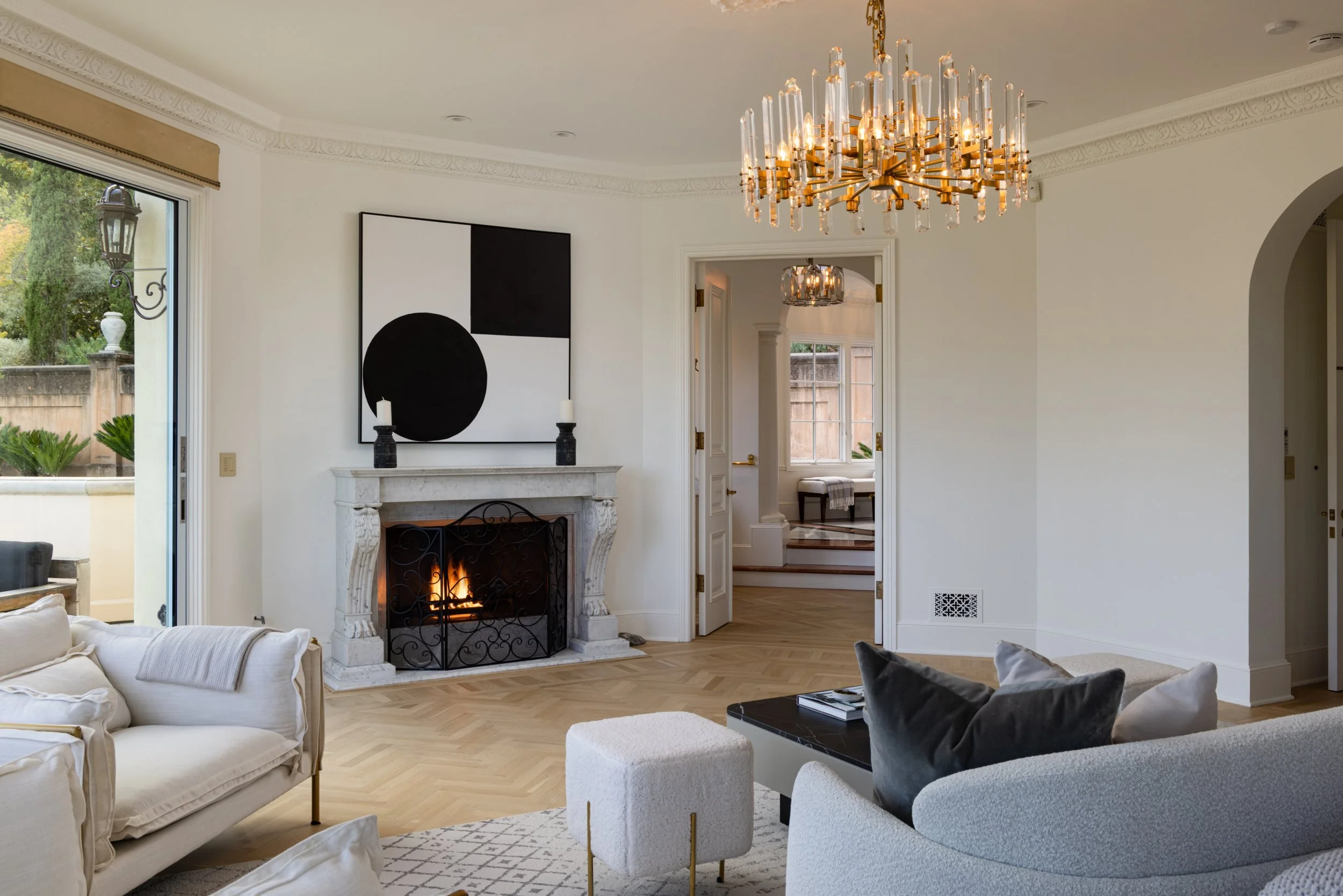 Sitting room with fireplace and gilded chandelier, 27 Upper Road, Ross
