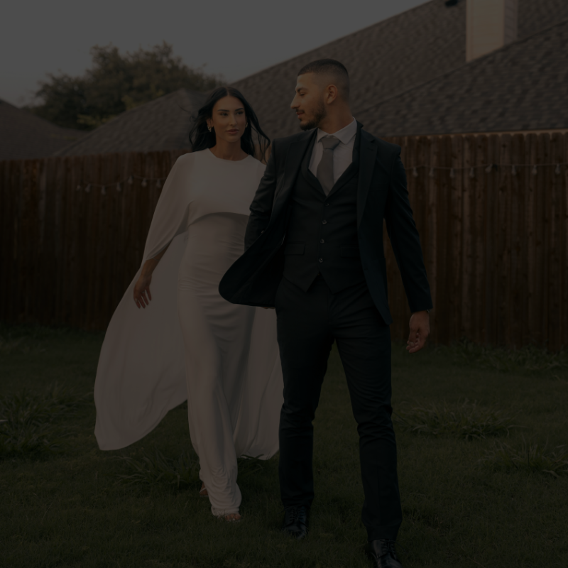 Couple walking together in wedding attire, symbolizing partnership and commitment in an everyday setting.