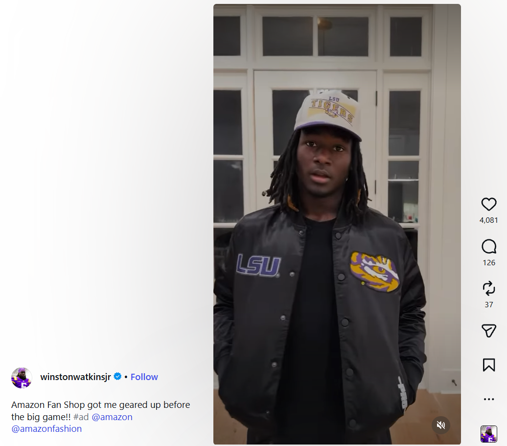Man wearing an LSU Tigers baseball cap and black LSU jacket in front of a glass-paneled door