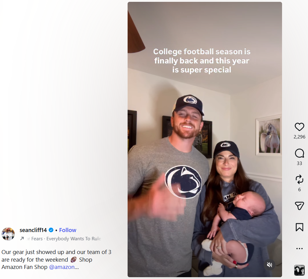 Penn State fan couple posing with their baby for college football season