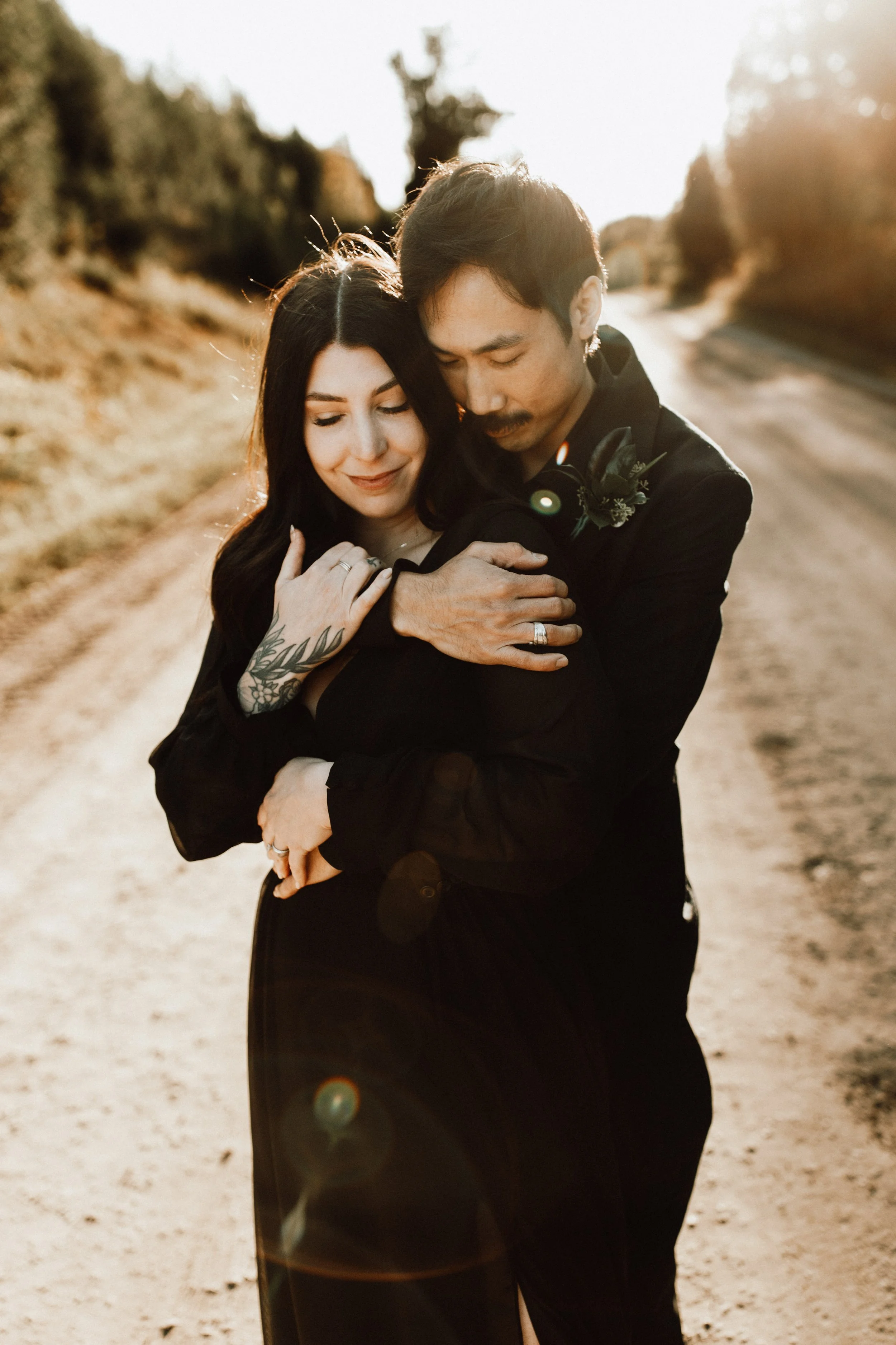 couple embracing backlit by warm sunlight