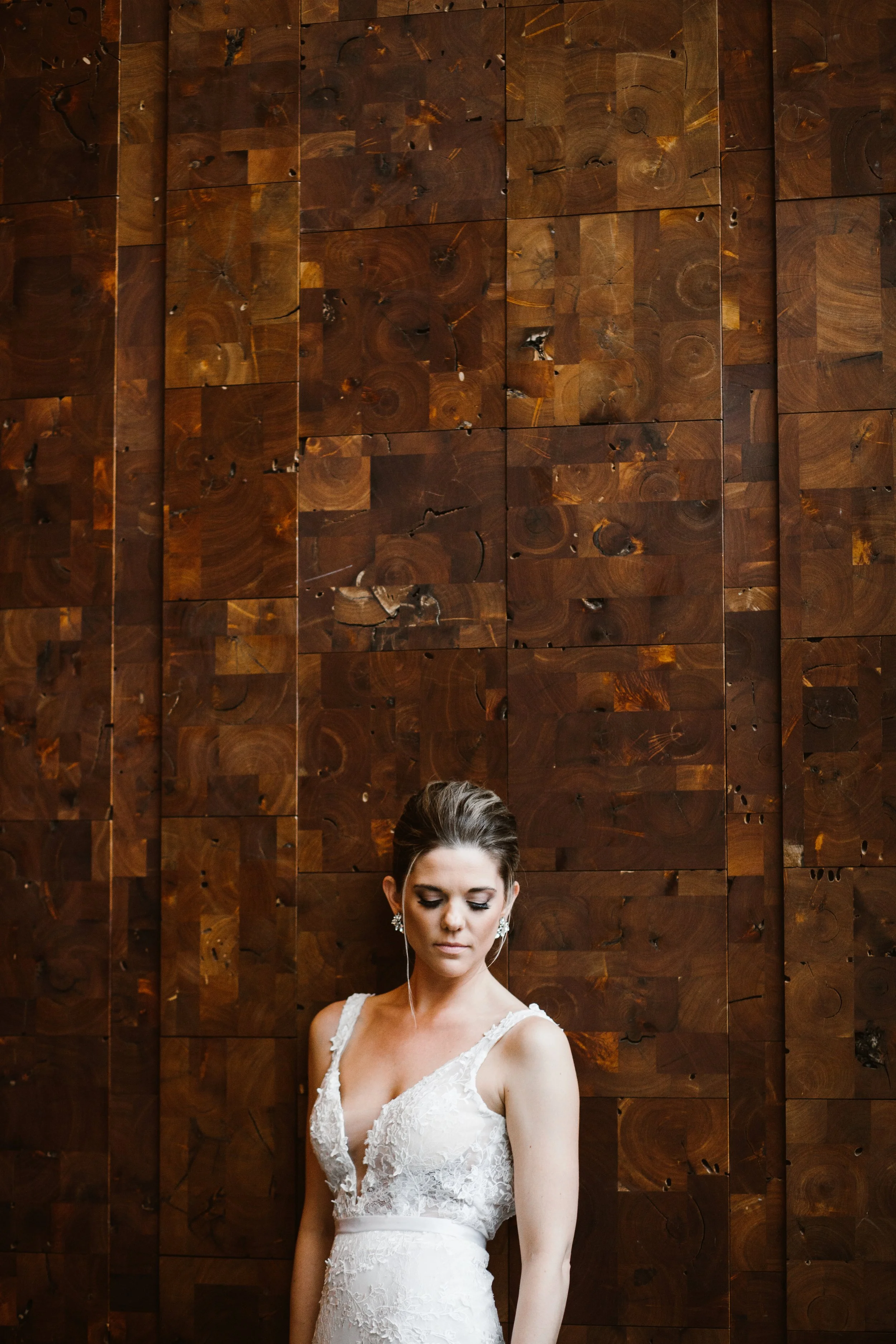 stunning bride in front of a brilliant wood wall