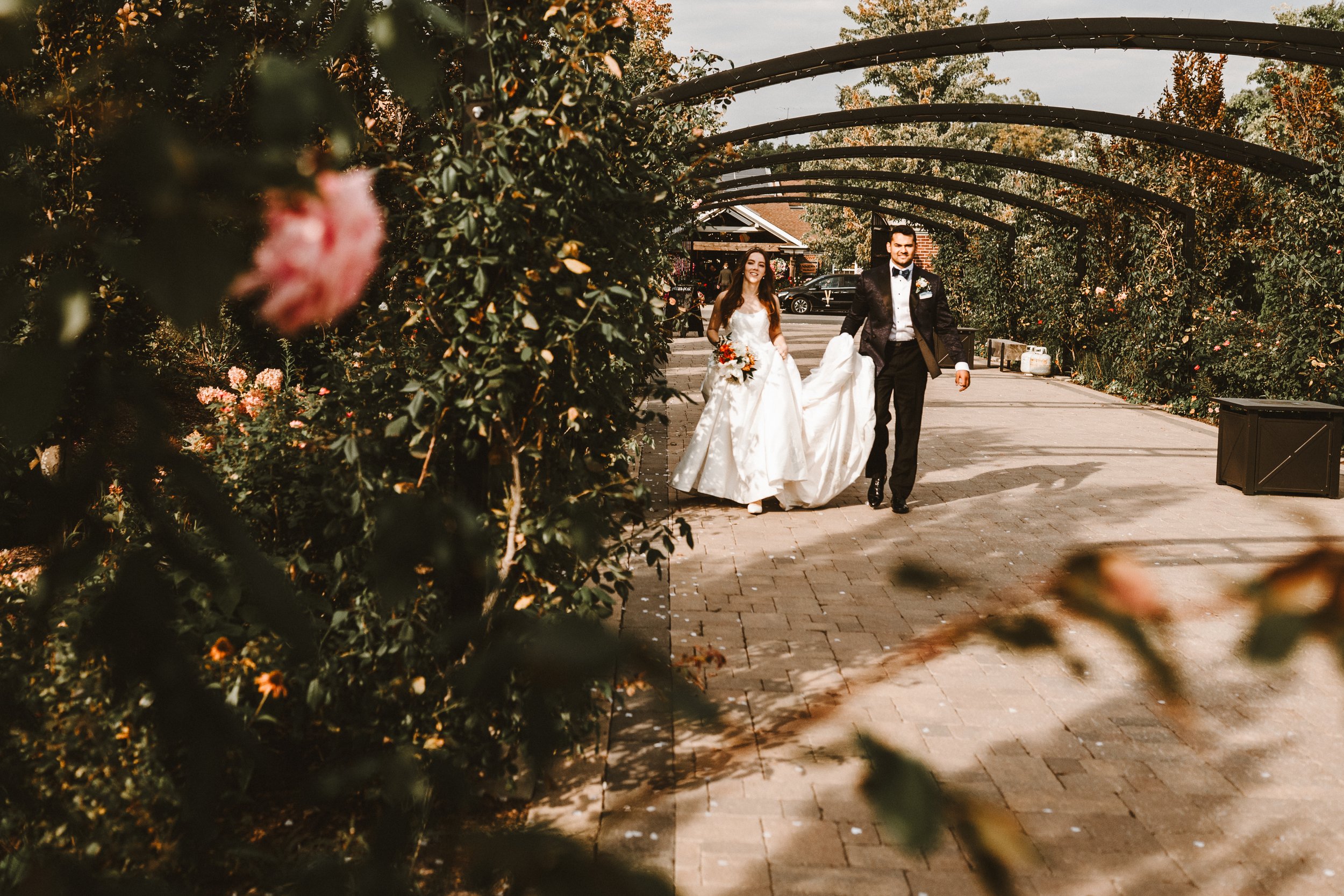 newly weds walking through Pillar and Post gardens