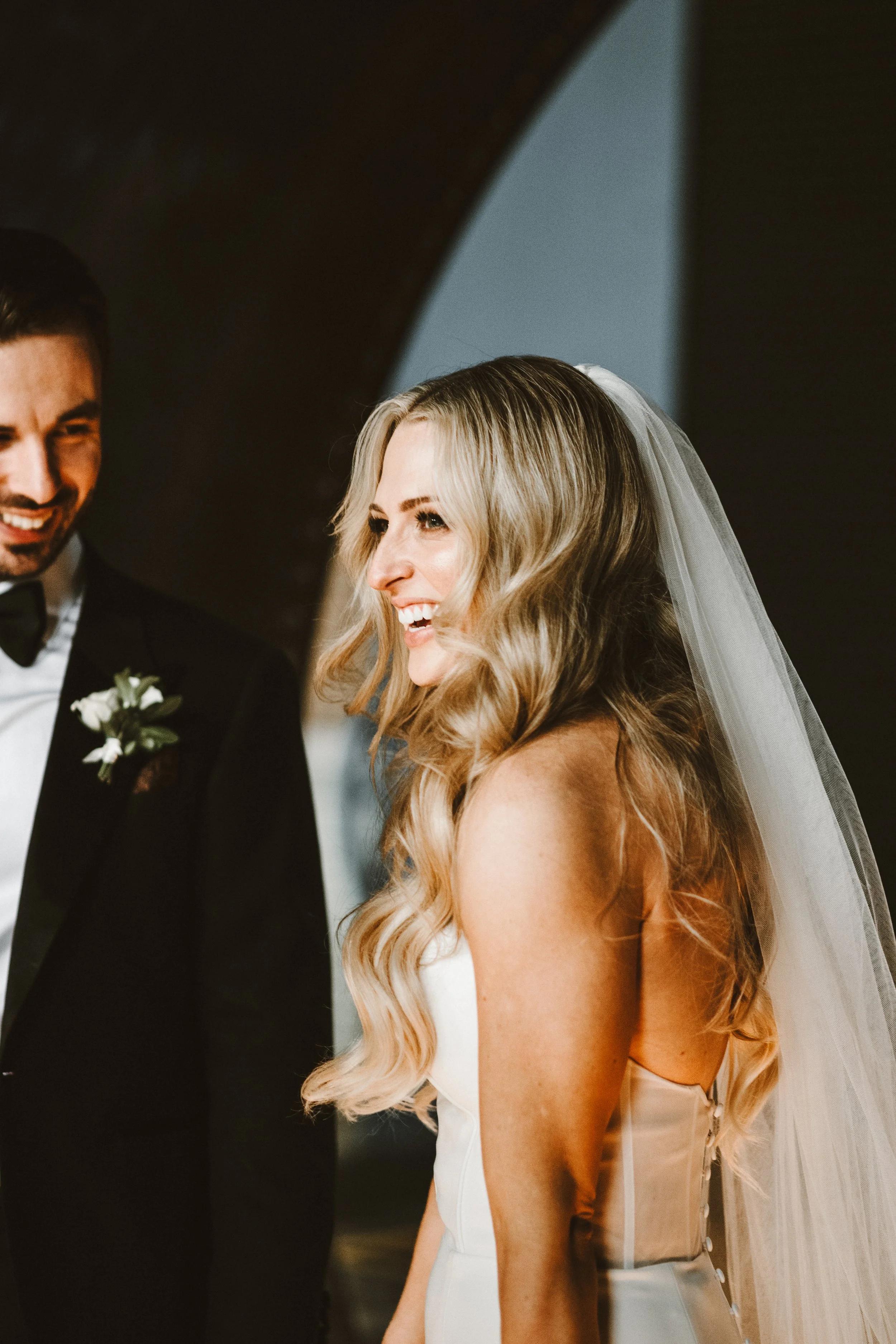bride and groom laughing in niagara falls powerplant