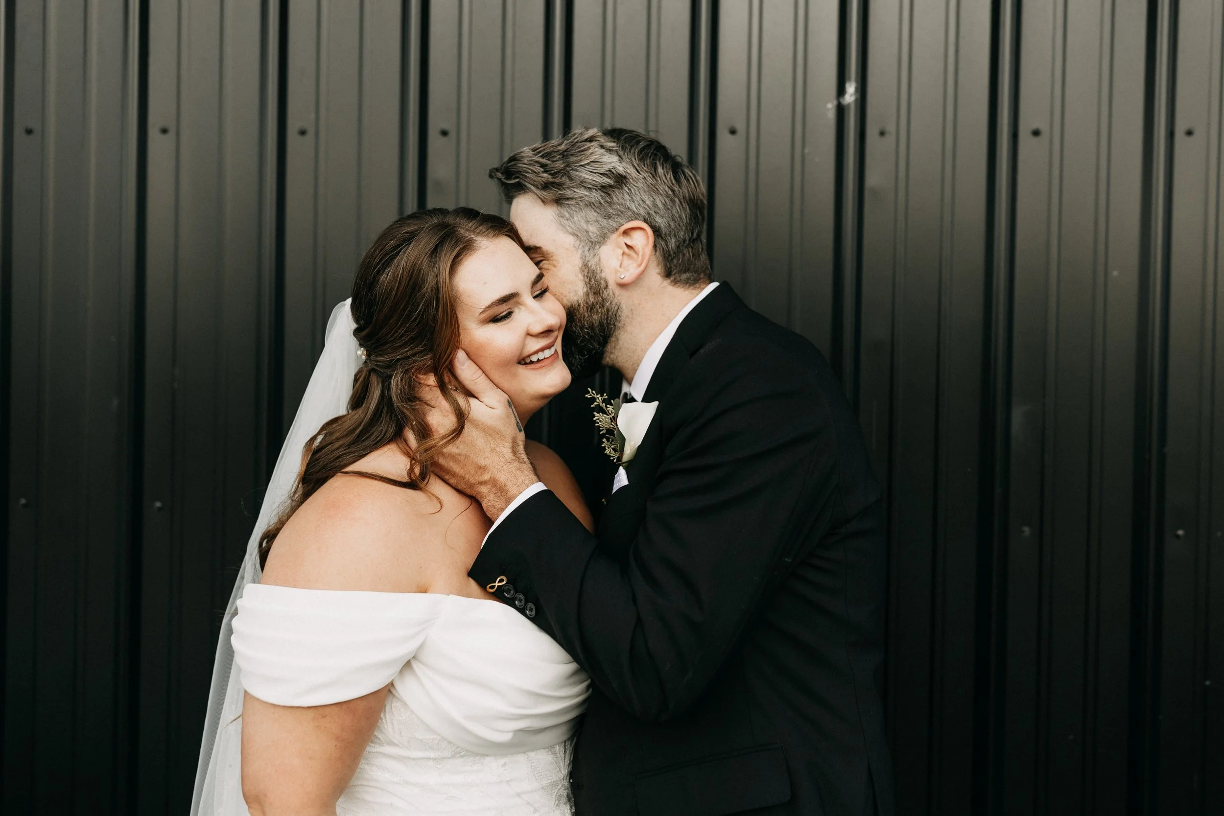 husband kissing his new wife on the cheek