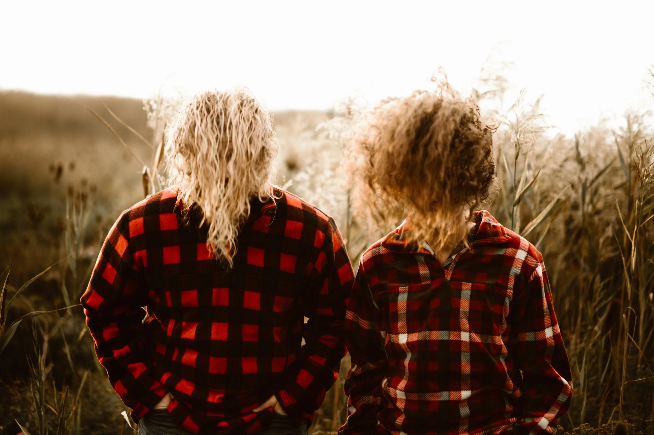 faceless young couple backlit with crazy hair