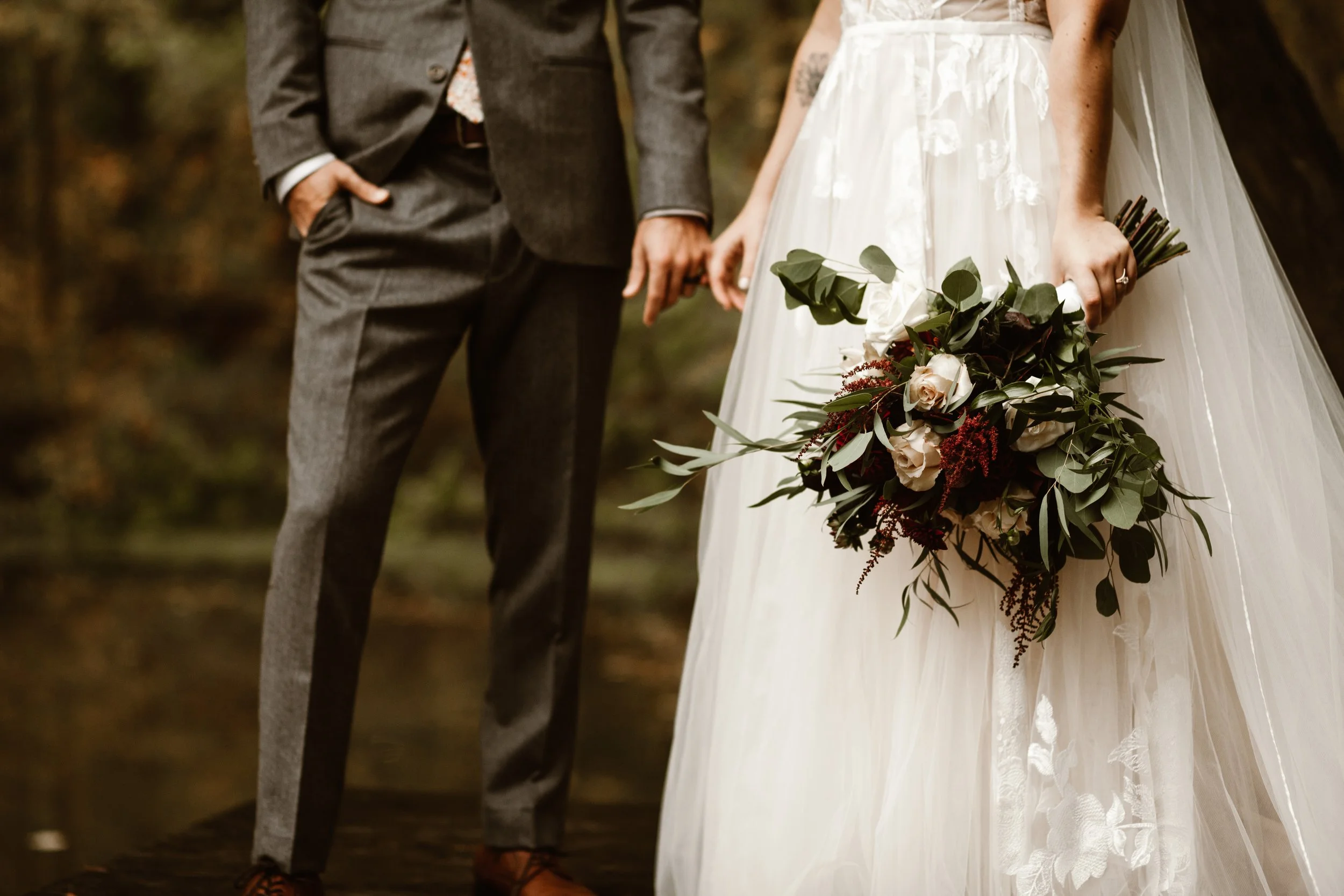 married folks holding hands outdoors