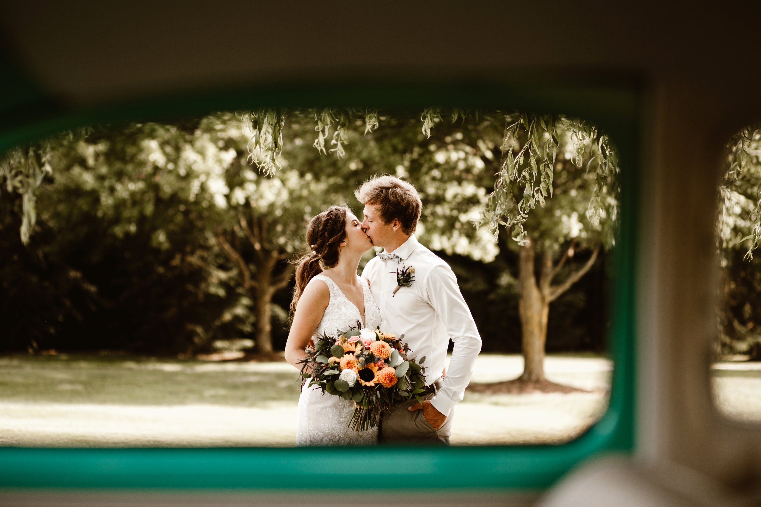 couple kissing through window of vintage volkswagen beetle