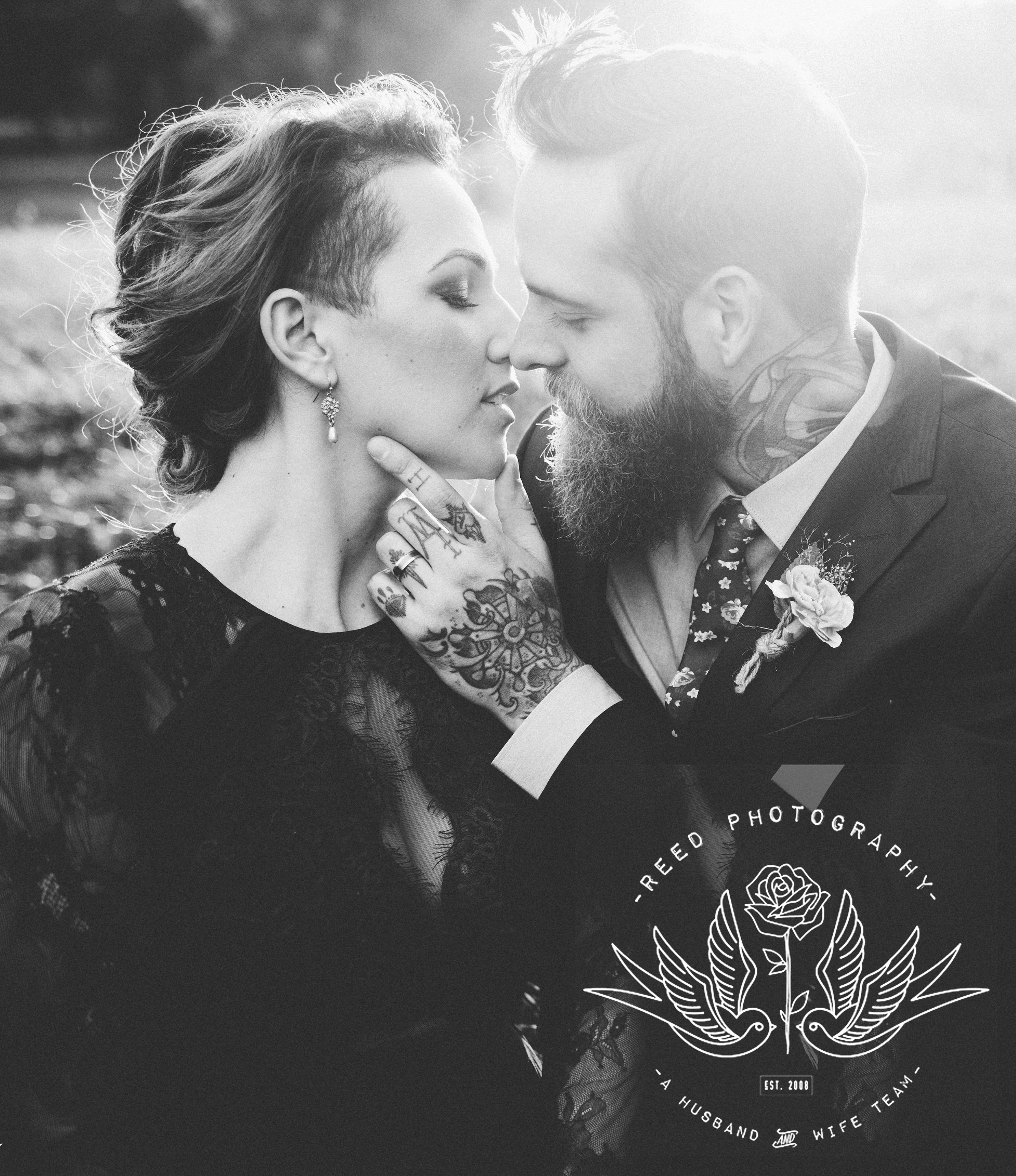 intimate black and white photo of young tattooed couple