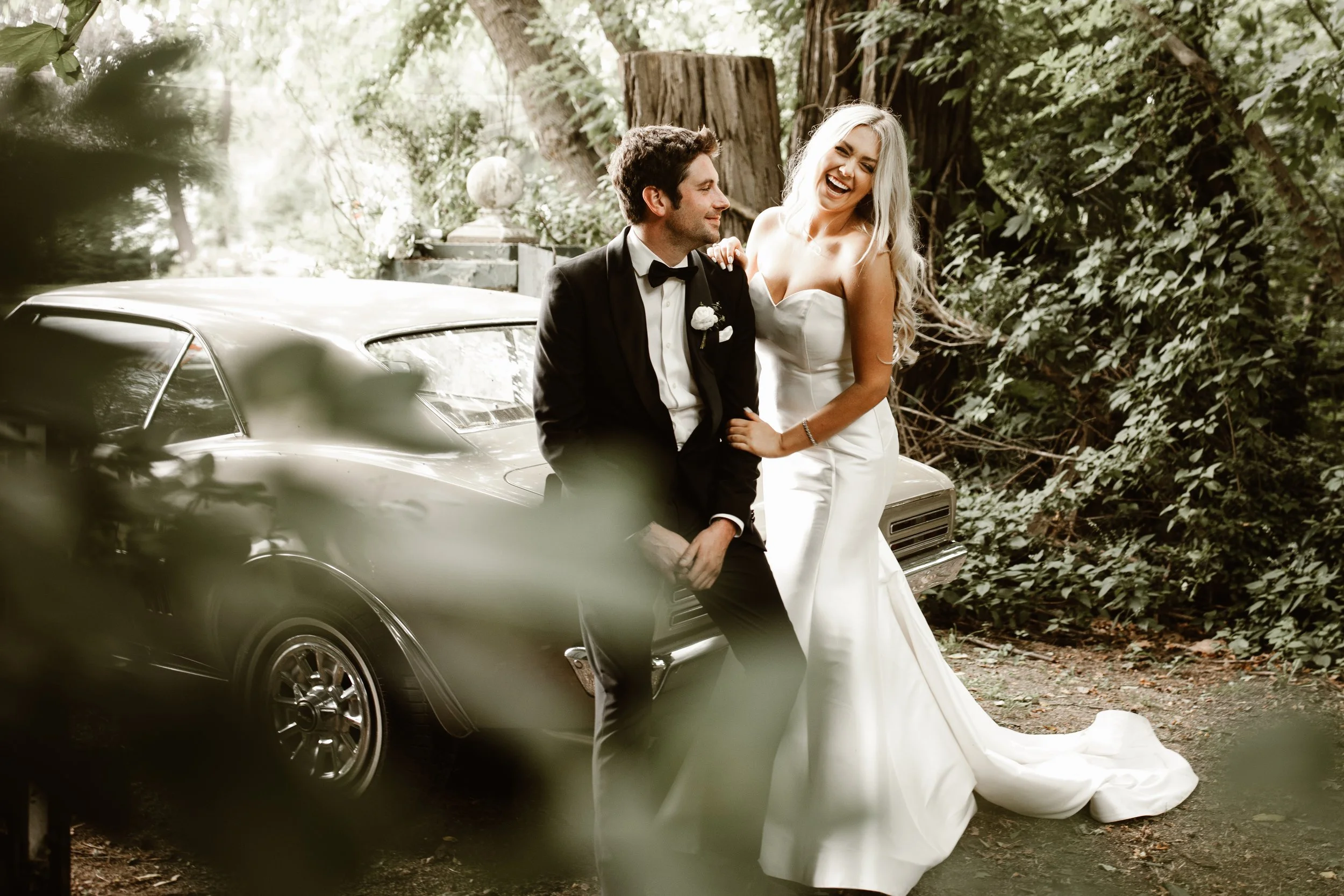 bride and groom sitting on vintage car in niagara on the lake