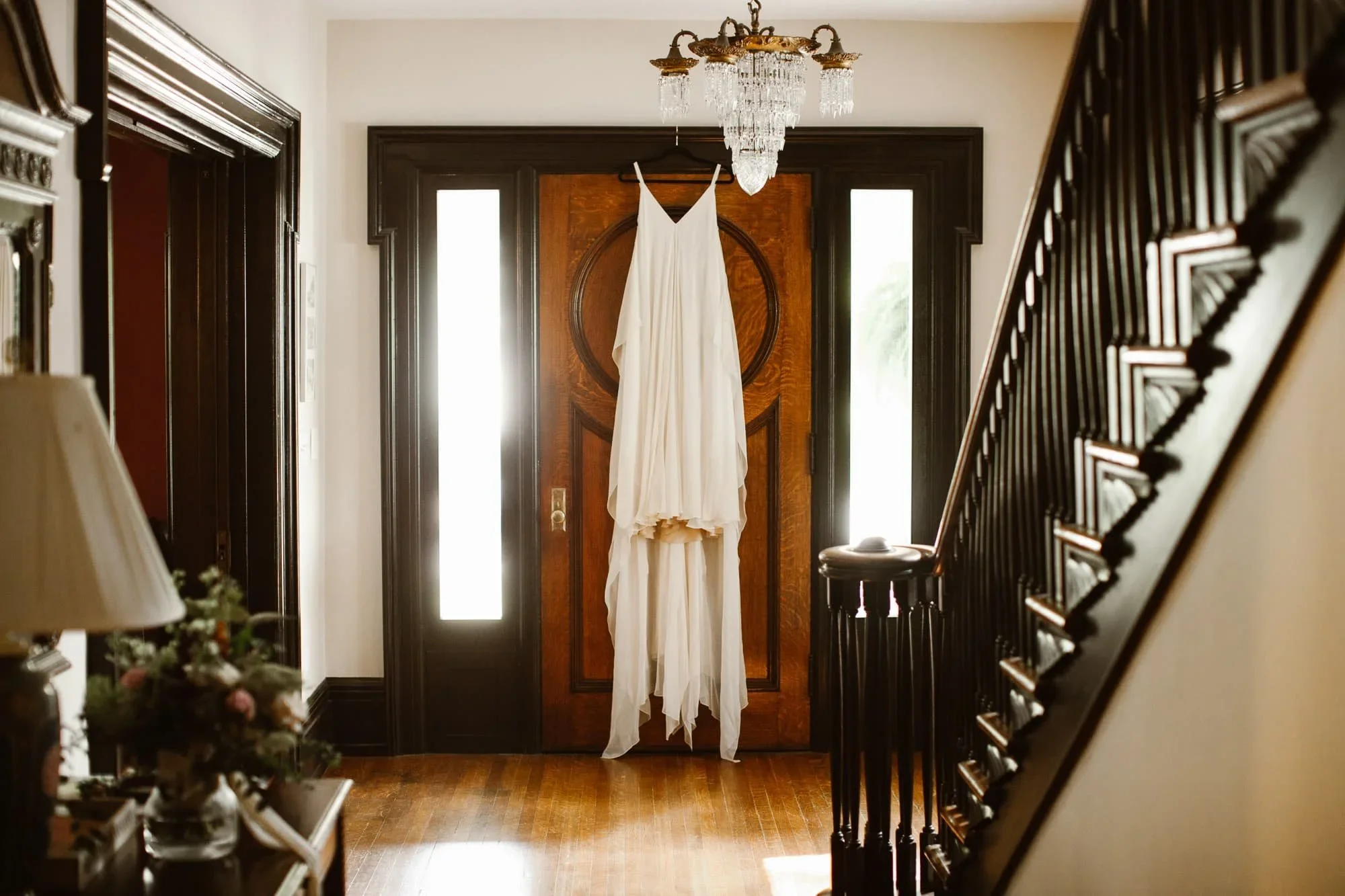 wedding dress hanging on wooden door in century home