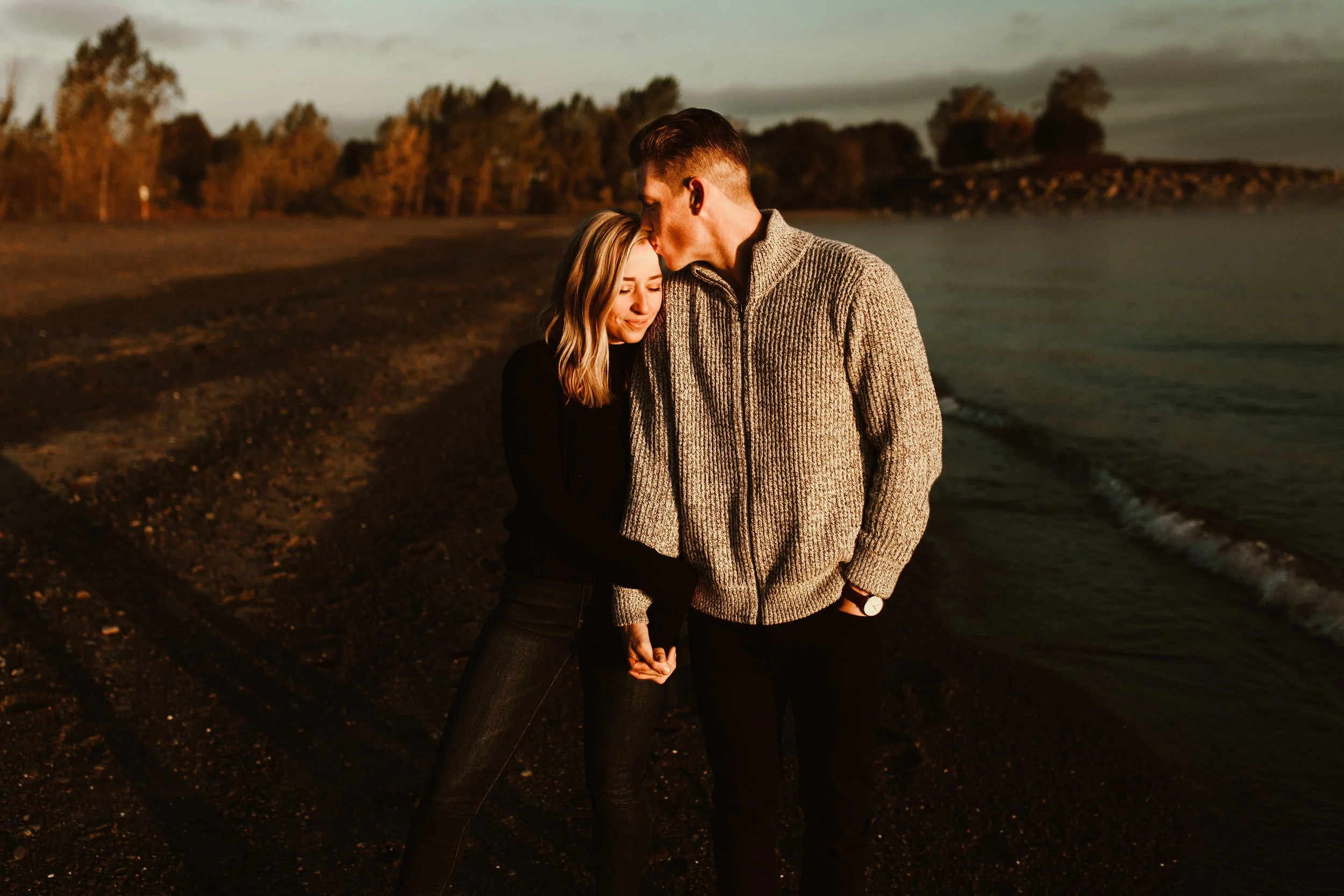 lakeside hard light photo of a guy kissing his girl 